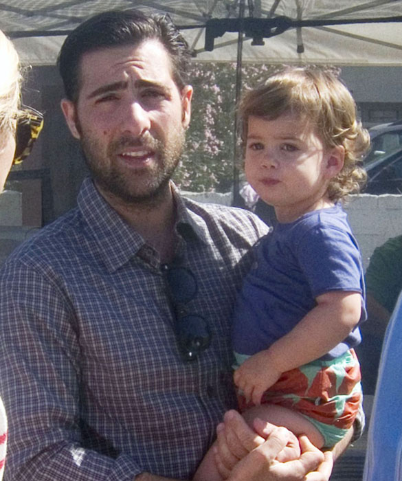 Jason Schwartzman holds onto his daughter Marlowe Rivers as they browse for fresh produce at the Hollywood Farmer's Market