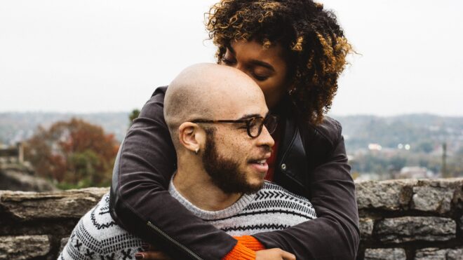 woman kissing mans head