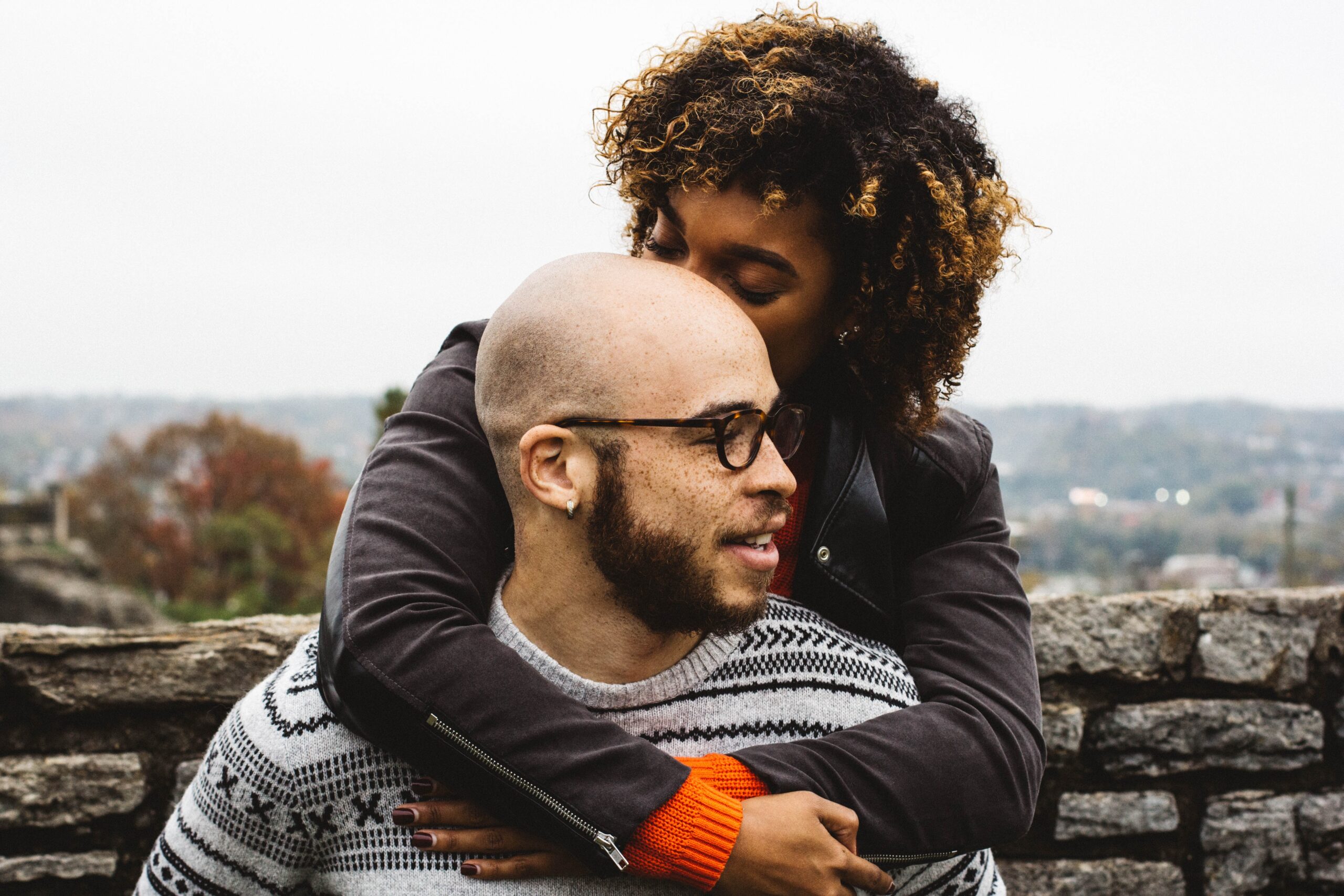 woman kissing mans head