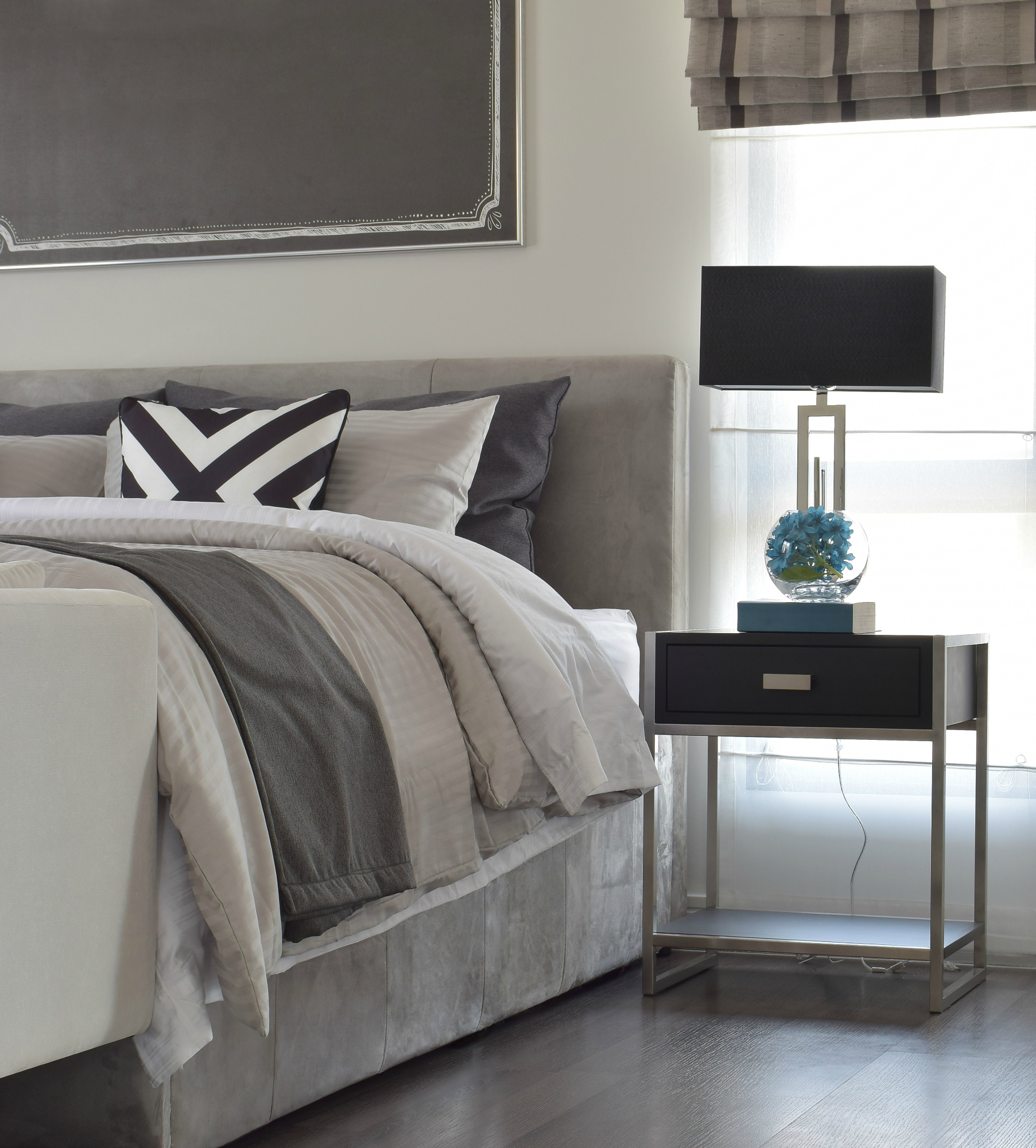 Modern classic style bedding with black shade lamp and graphic rug on the floor