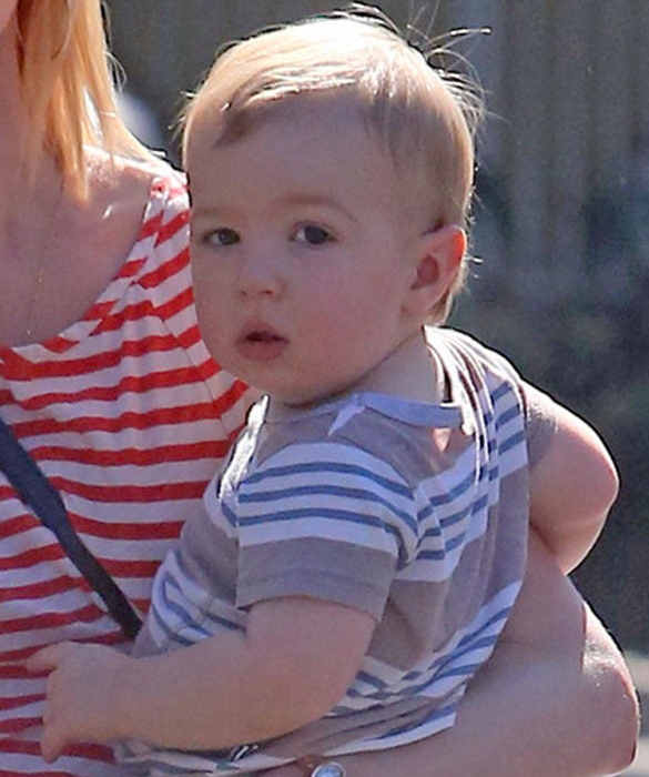 January Jones holds on tight to her one year old son Xander, as the twosome and a guest head out to lunch in Los Angeles