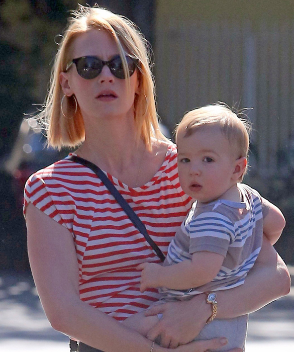 January Jones holds on tight to her one year old son Xander, as the twosome and a guest head out to lunch in Los Angeles