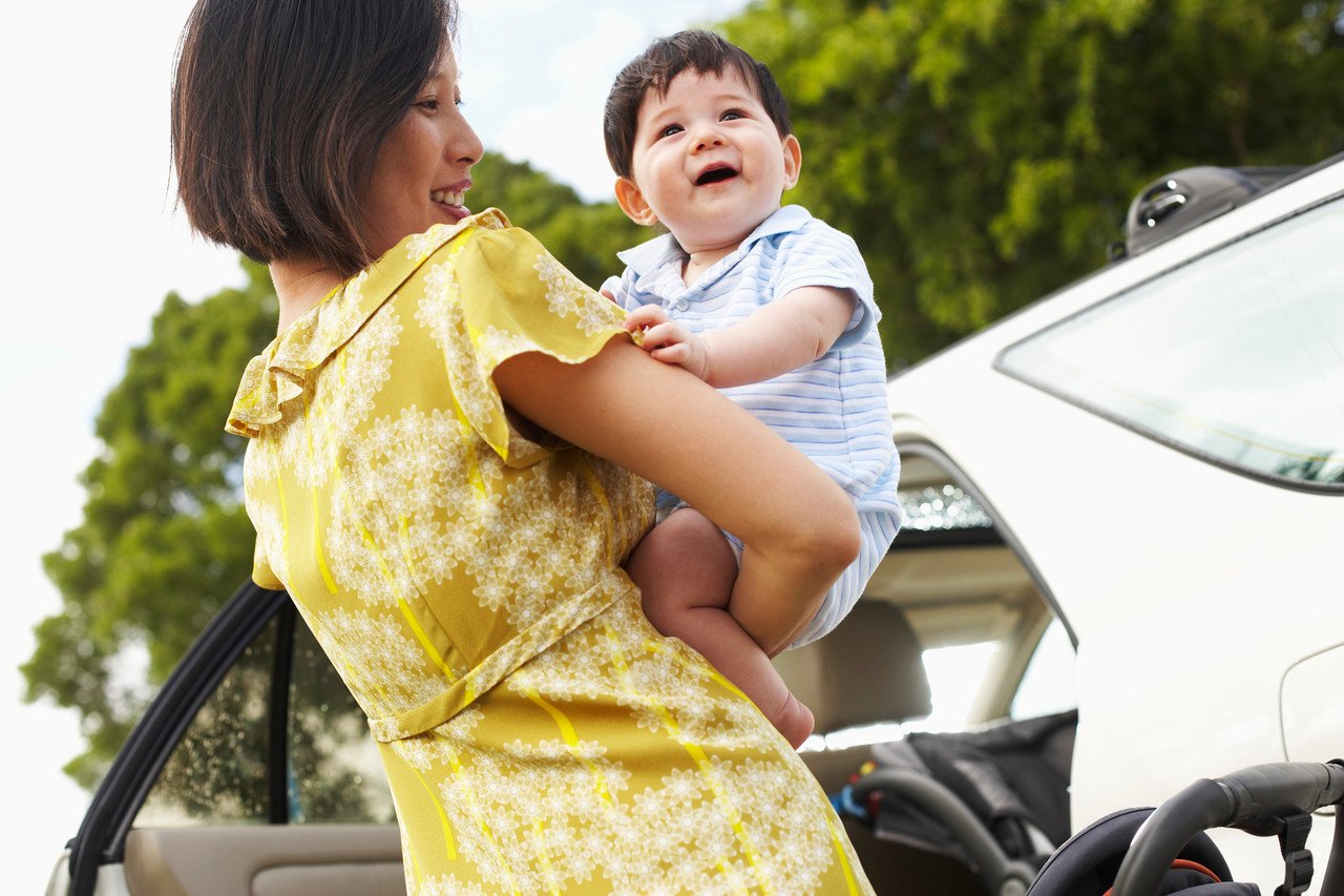 Mother Putting Baby in Car