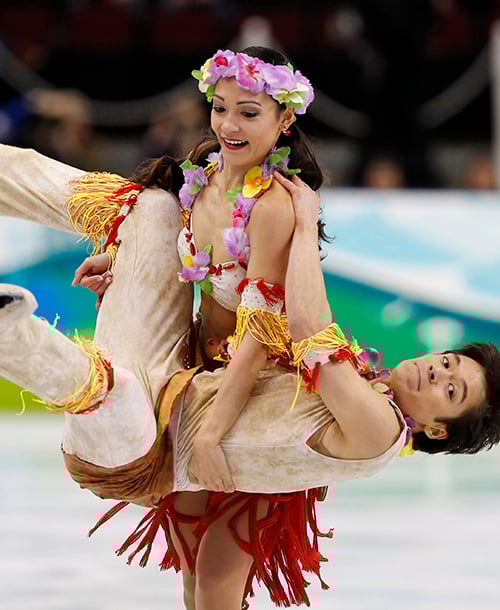 Germany's Christina Beier carries her partner William Beier during their routine in the ice dance original dance figure skating competition in Vancouver