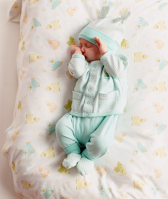 82674-6-sleeping-baby-calm-relaxed-cute-outfit-newborn-bed.jpg