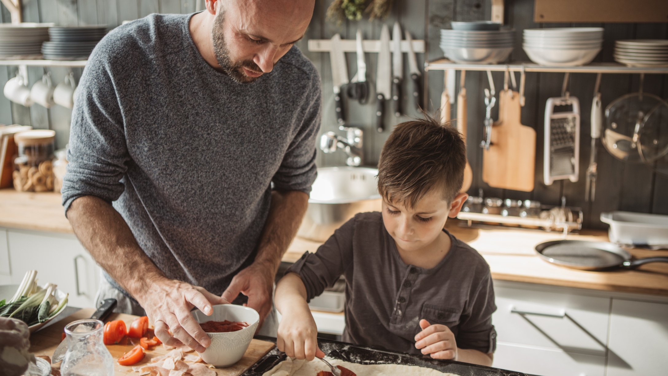 Dad preps dinner with young son