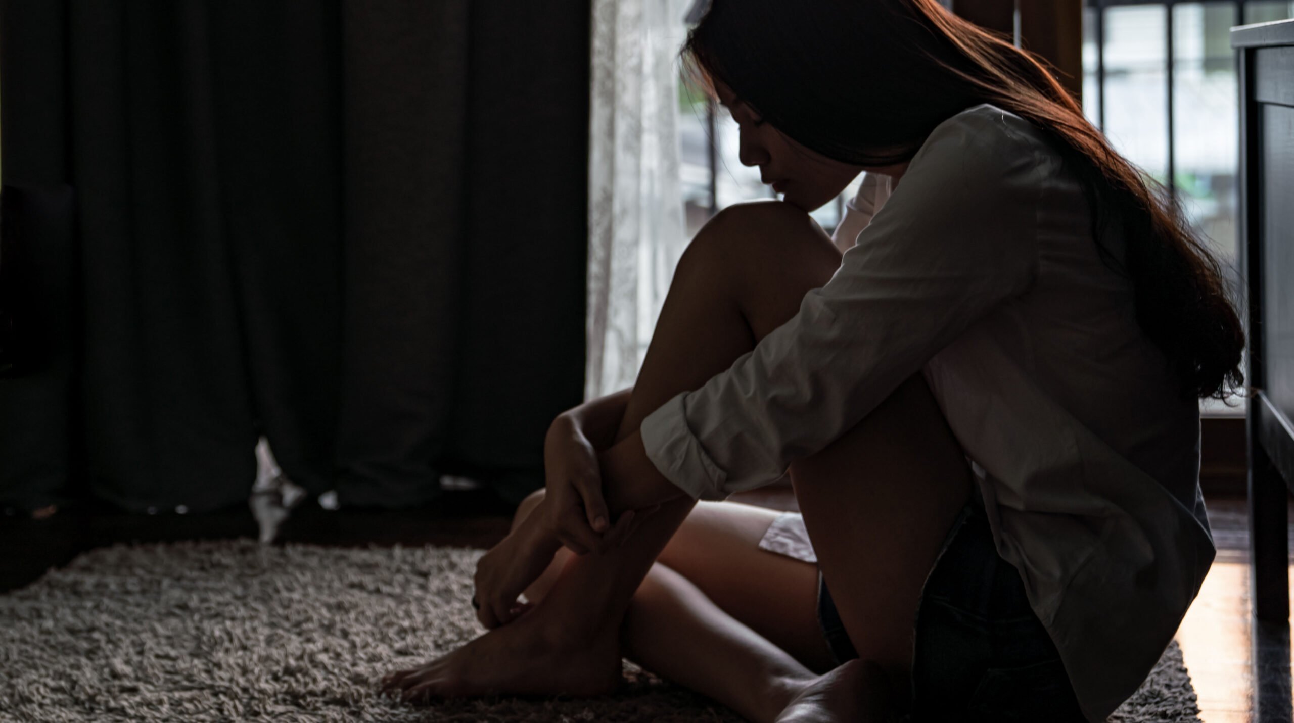 Sadness teenage girl sitting alone on the floor