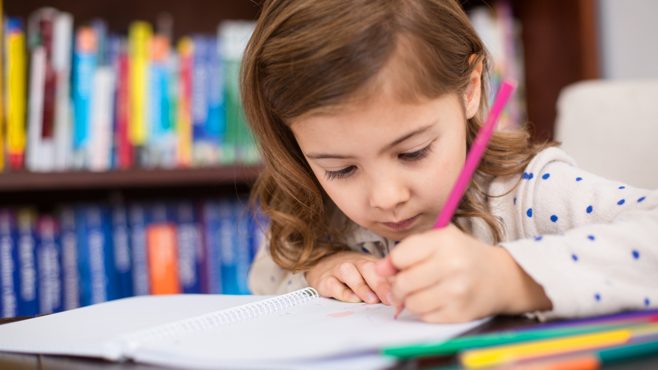 Kindergarten girl working on homework