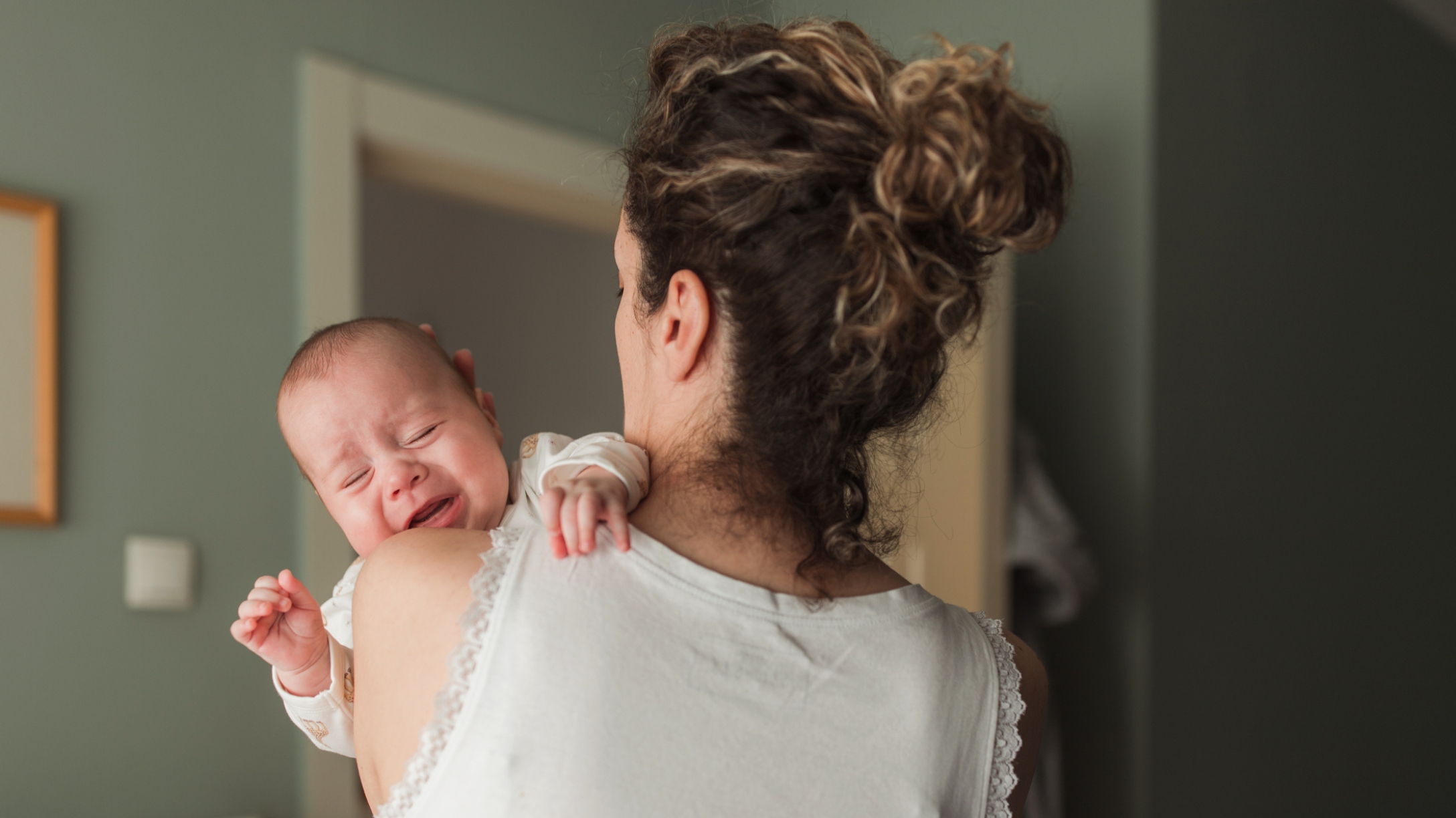 New mom holds crying baby