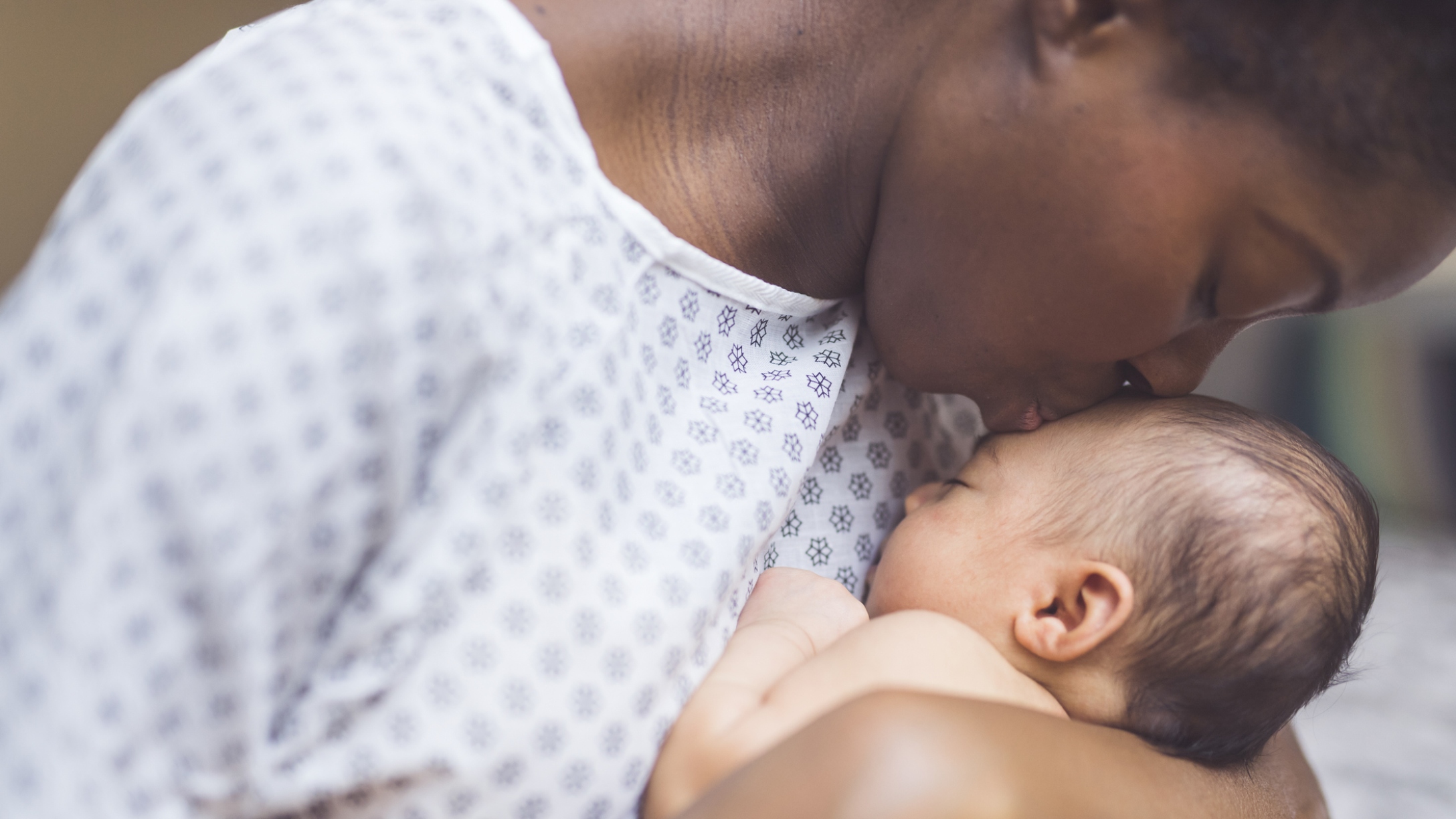 Mom kisses baby shortly after birth