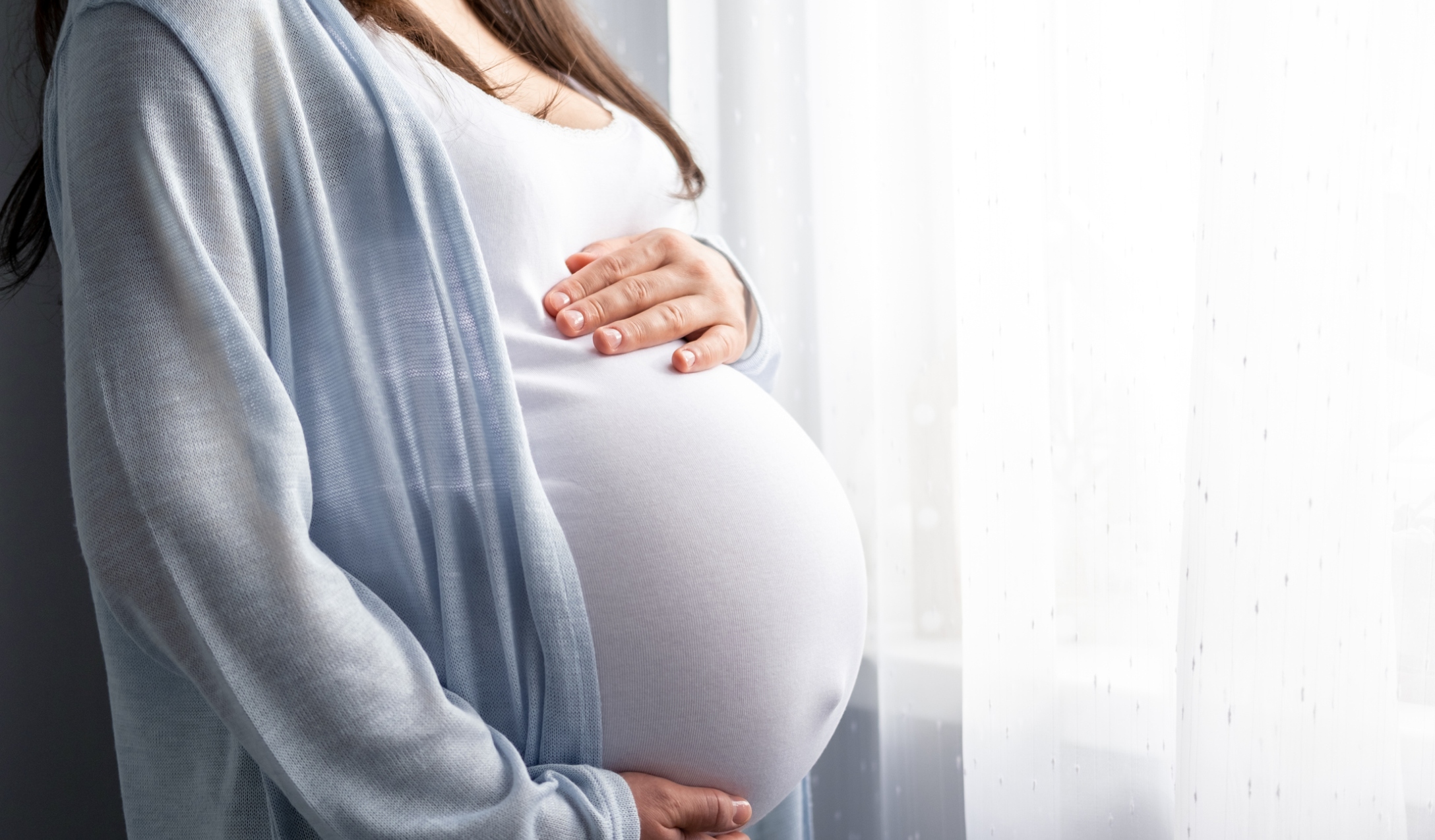 Pregnant mom holds her belly
