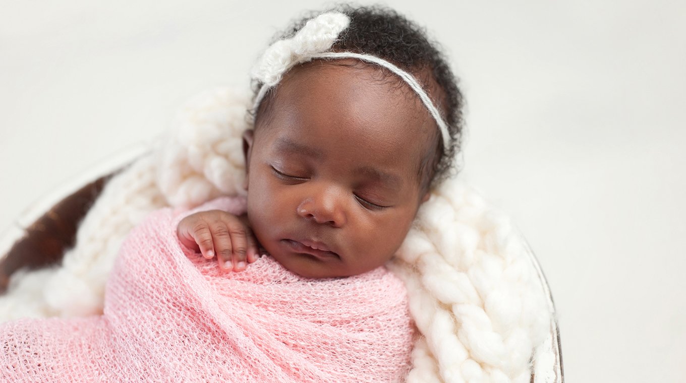 Newborn Baby Girl Sleeping in Bowl