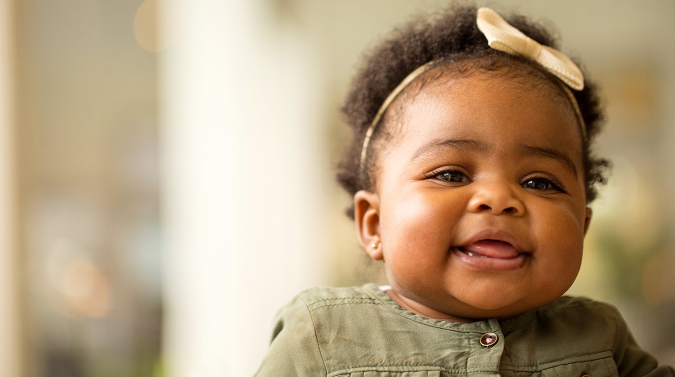 Portrait of a happy little girl laughing and smiling.