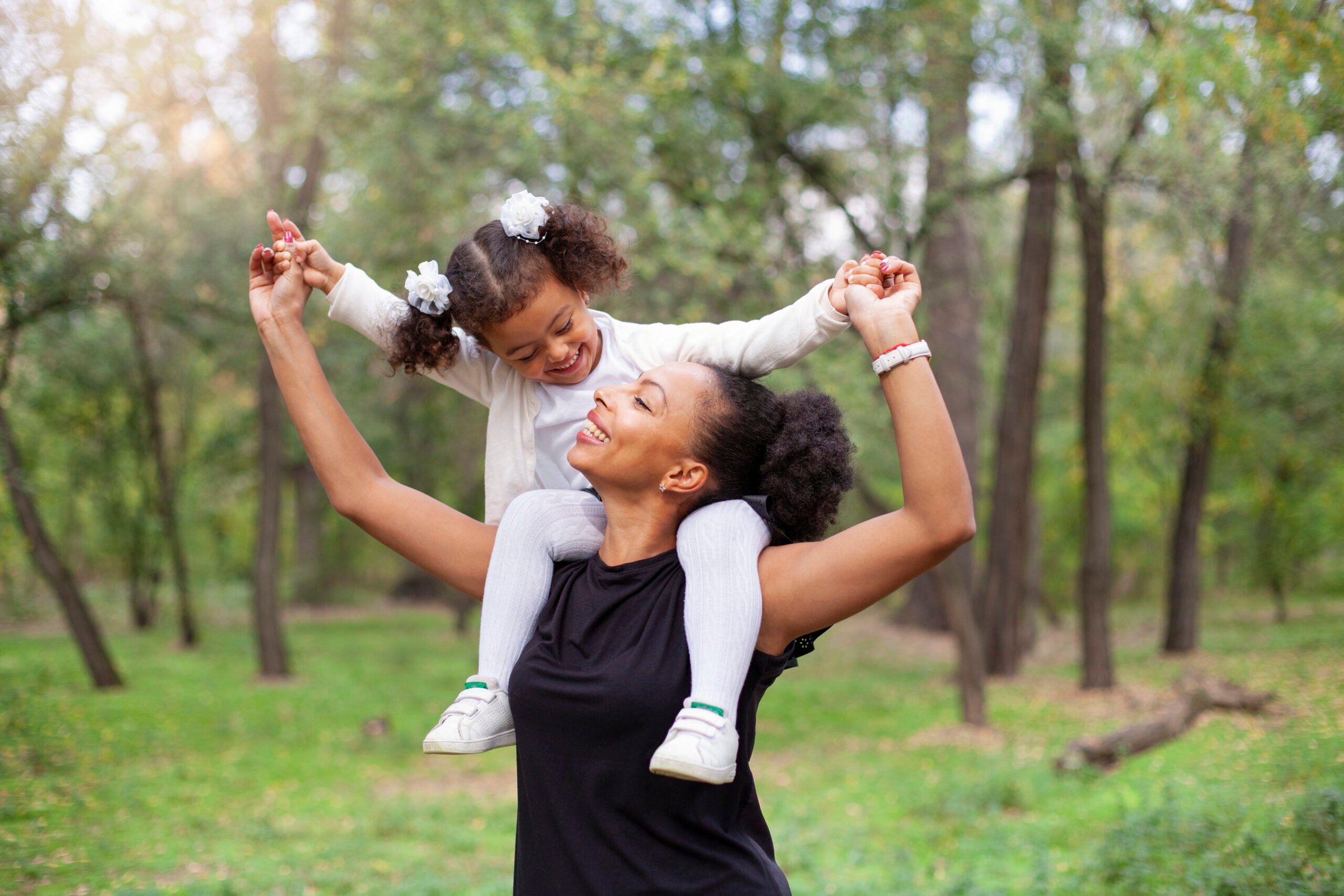 African American mother and daughter in park
