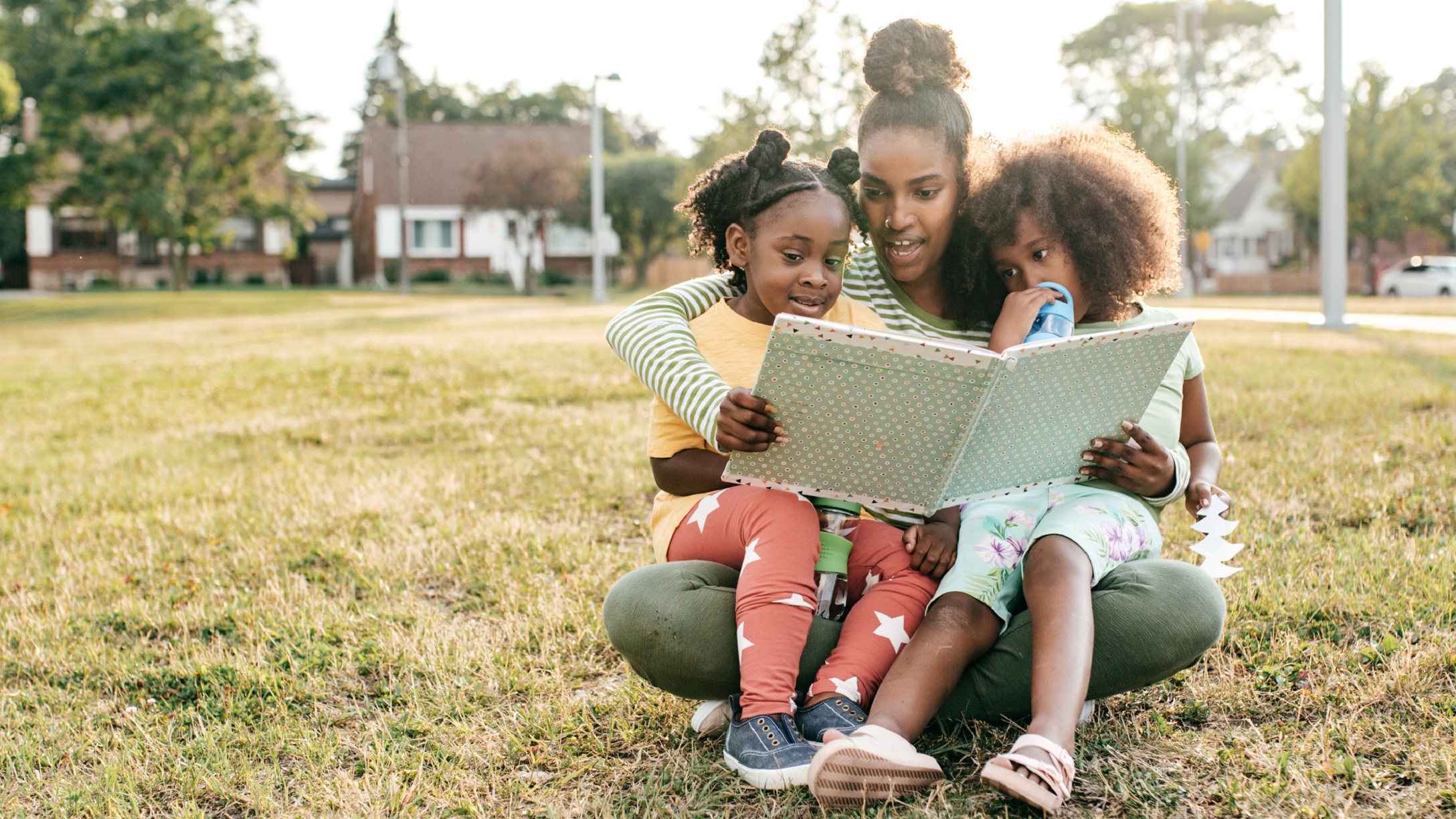 mom reading to daughters - The Importance of Reading Stories by Black Authors