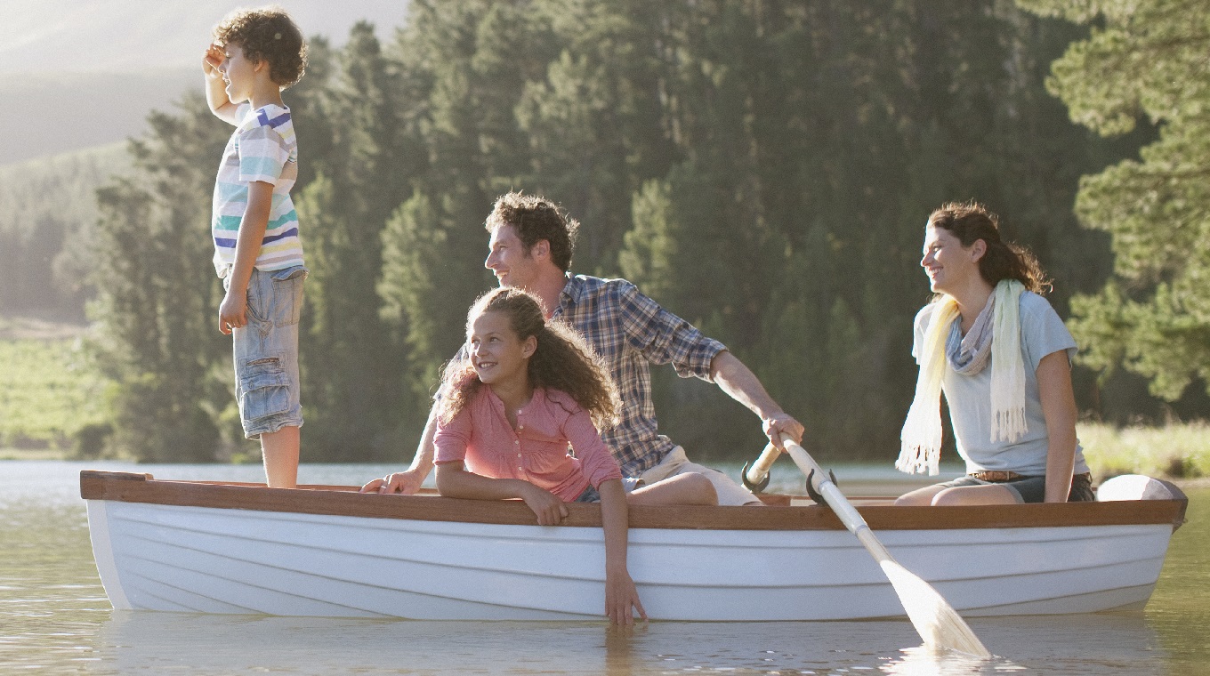 Family in rowboat on lake