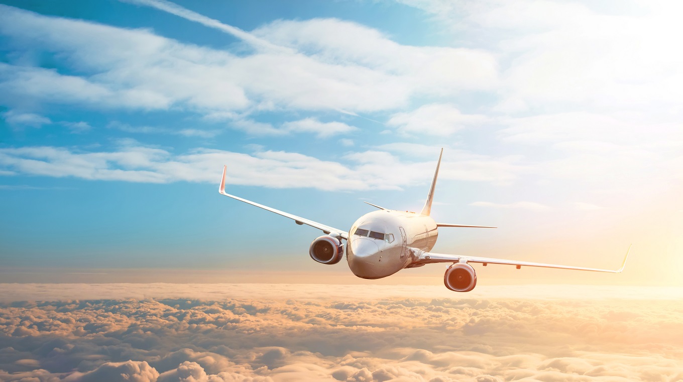 Passenger plane, business trip, travel concept. Flying evening sunset.