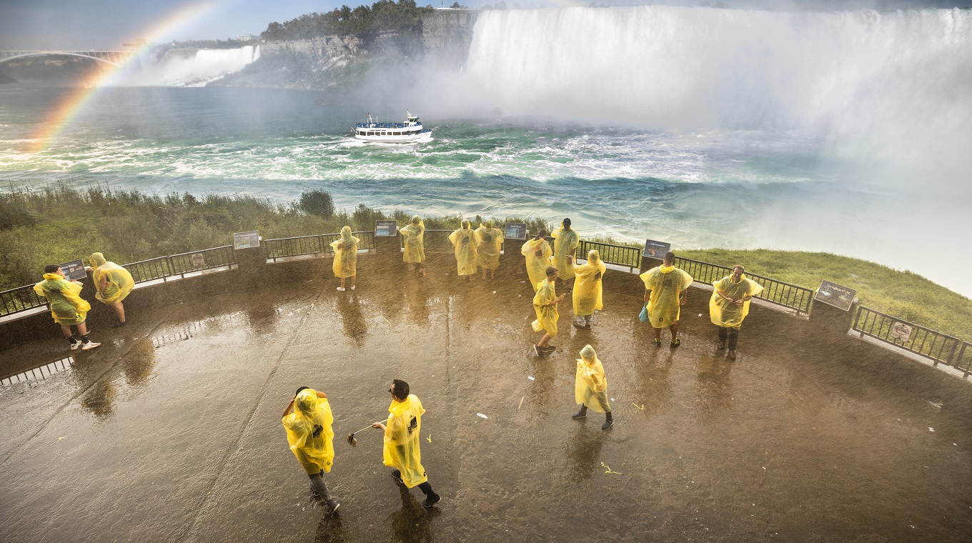 Tourists wear ponchos to protect from the wet mist in Niagara Falls Ontario Canada
