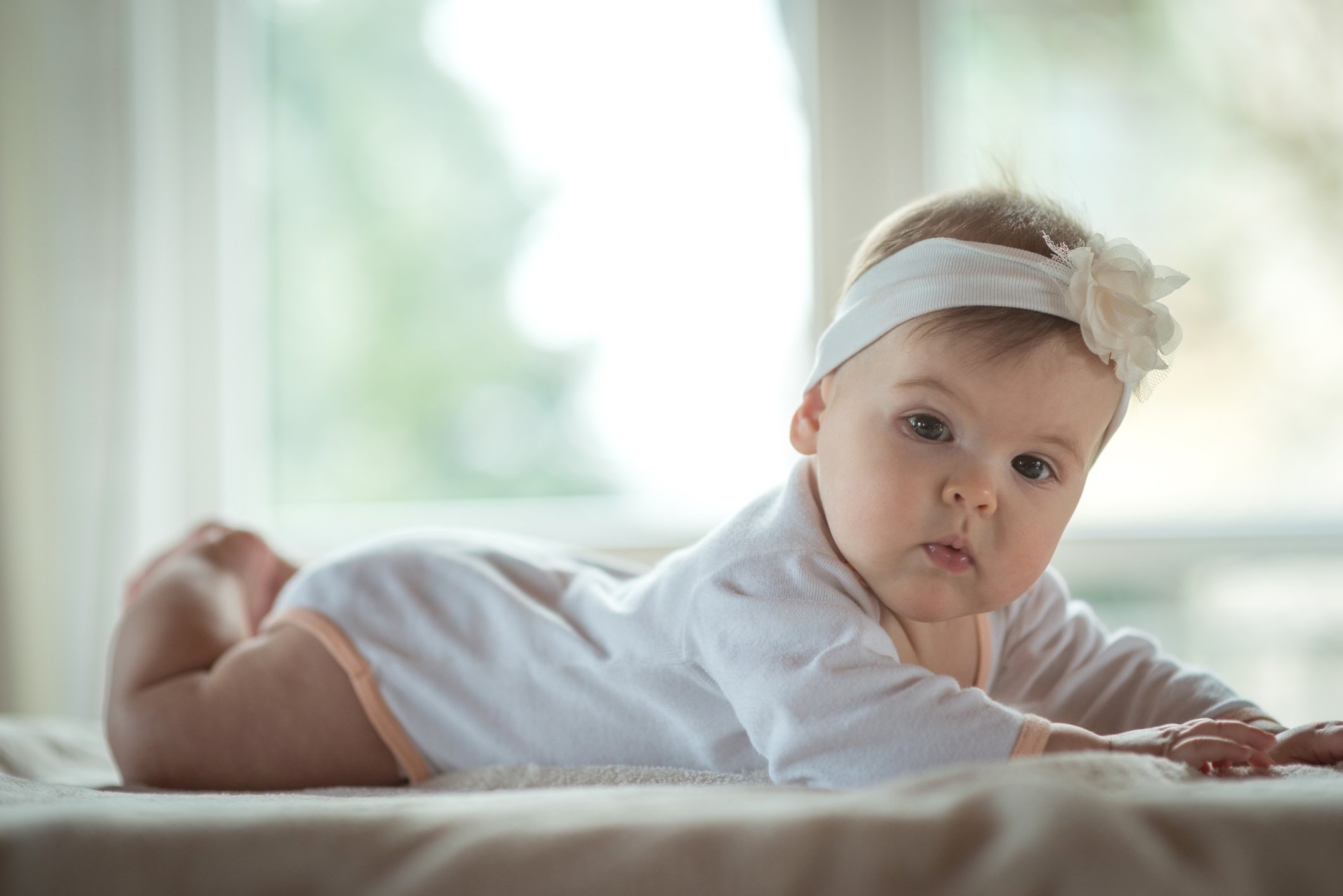 Beautiful little girl lying down and posing
