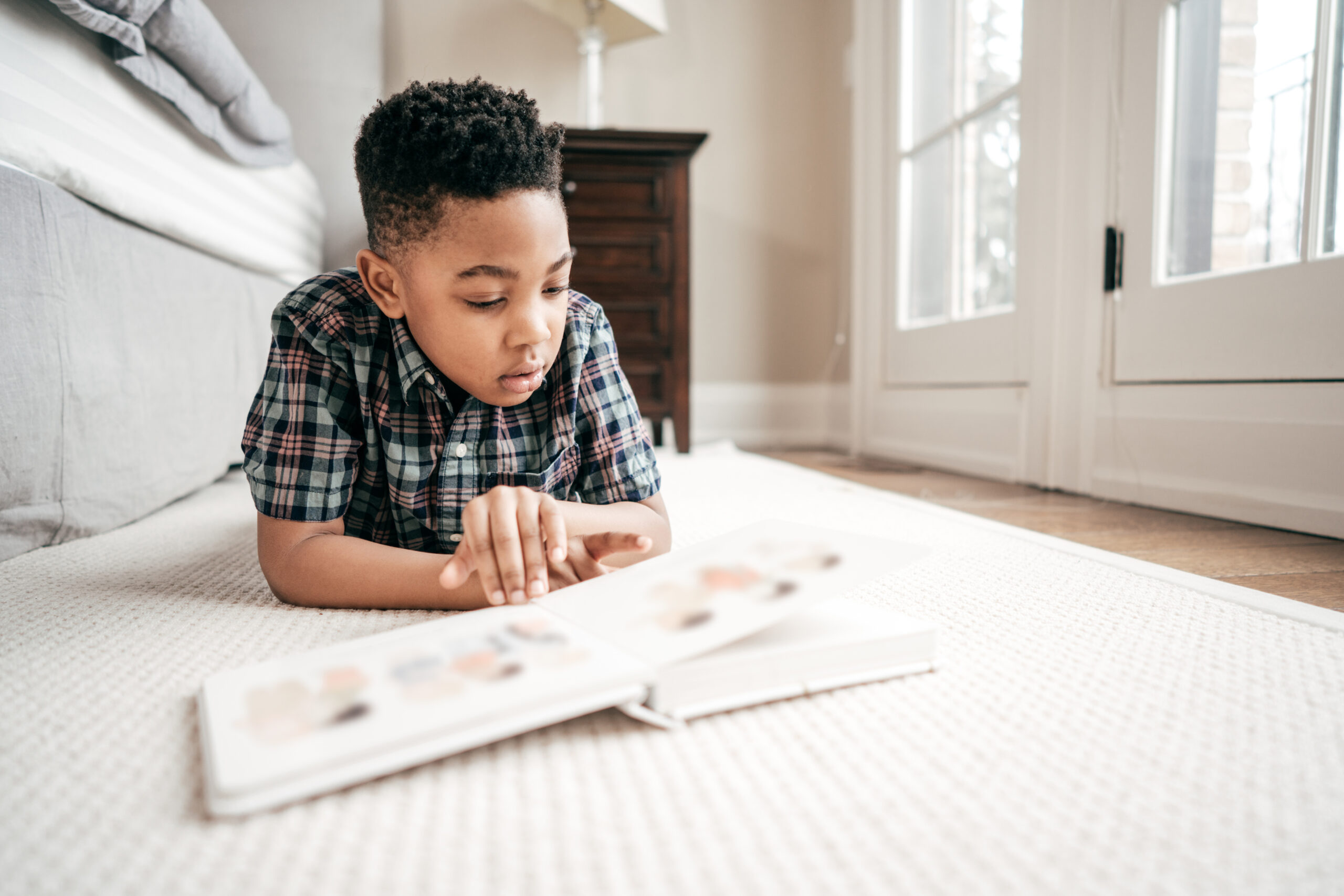 boy reading on ground