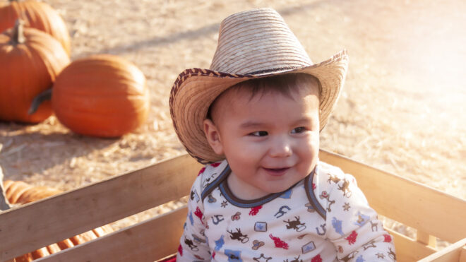 Baby wearing a cowboy hat