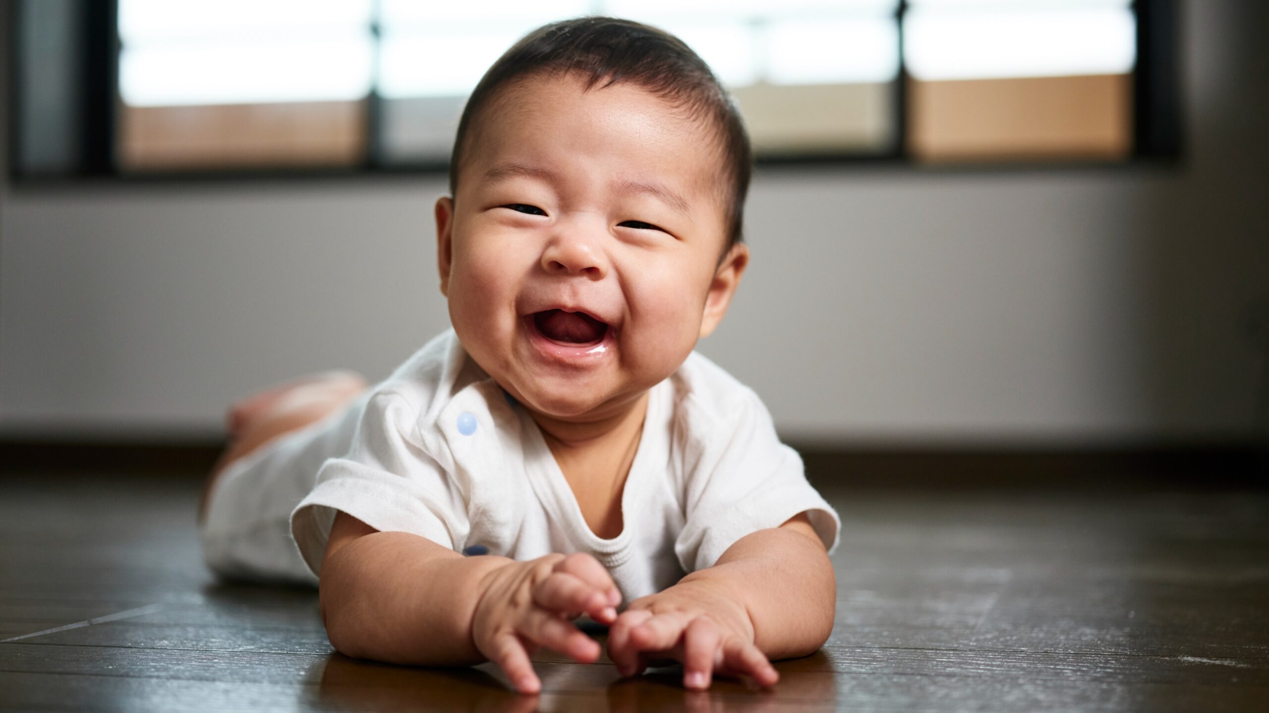 smiling baby boy playing on the floor