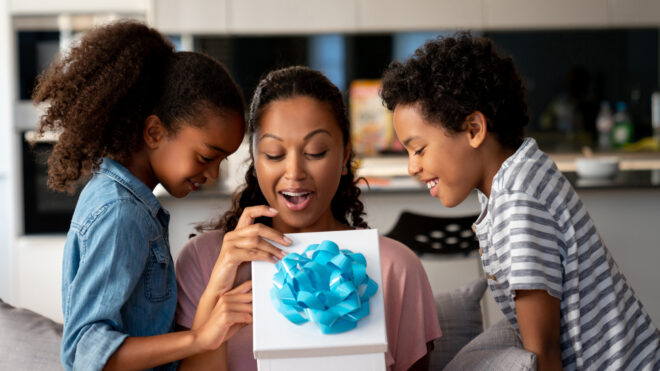 mom opening present with kids