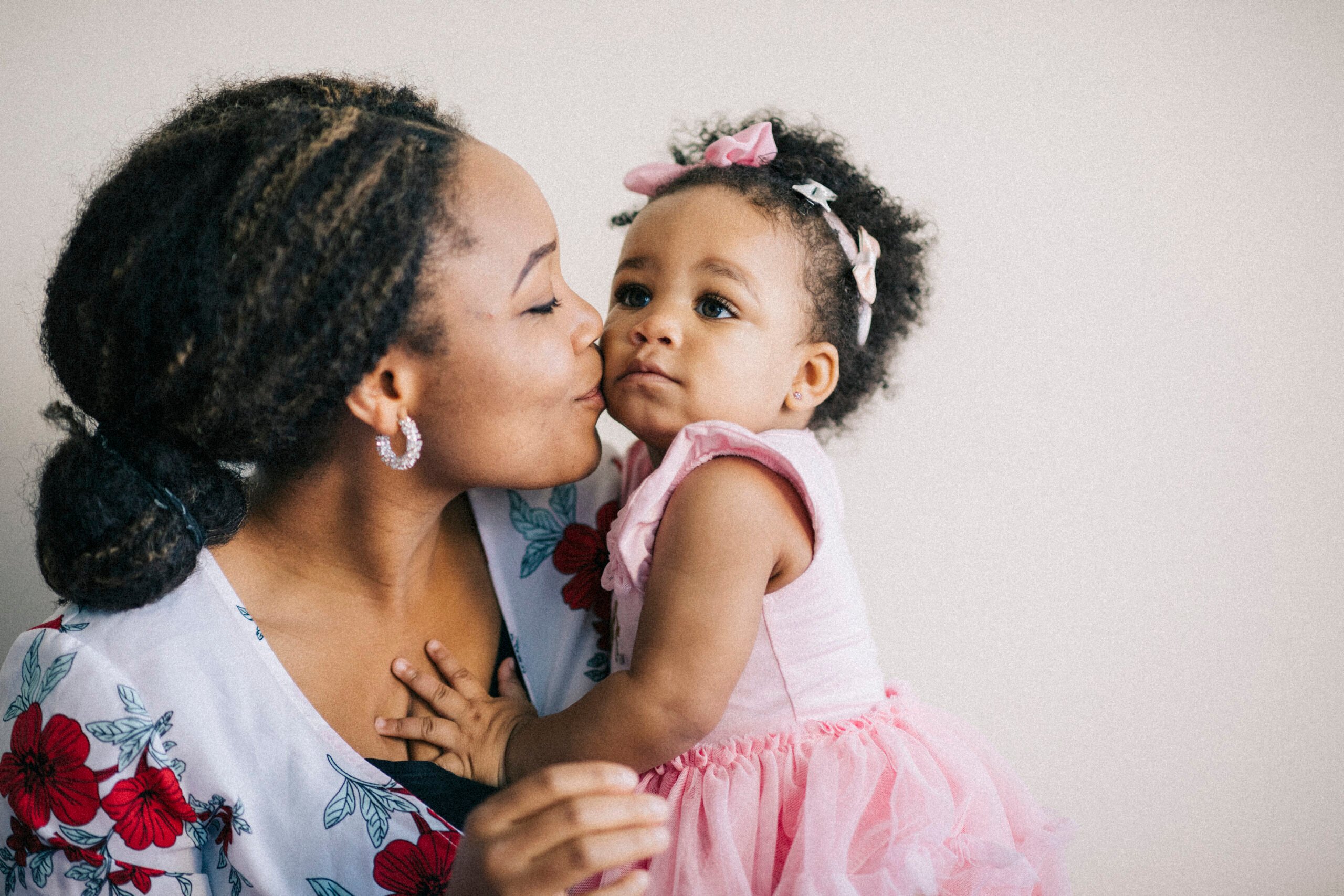 Caring young mother and her one year old baby girl having fun together.