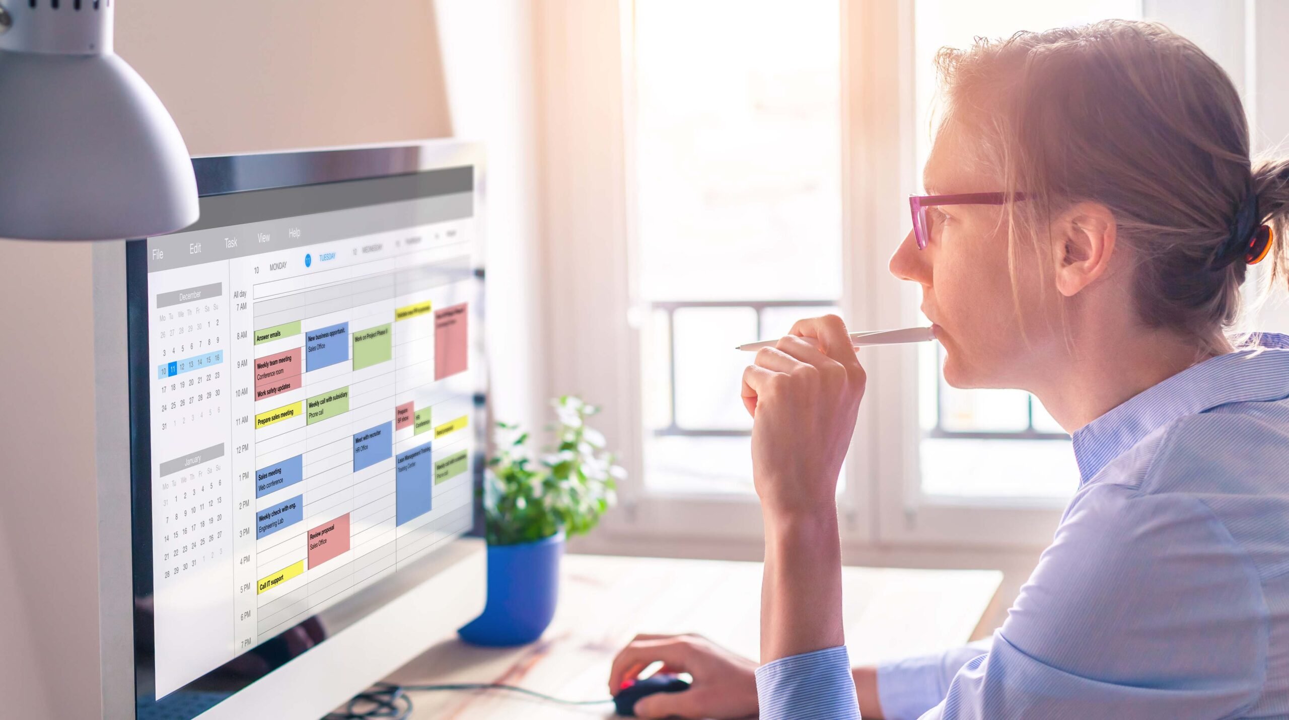 Person using calendar on computer to improve time management, plan appointments, events, tasks and meetings efficiently, improve productivity, organize week day and work hours, business woman, office