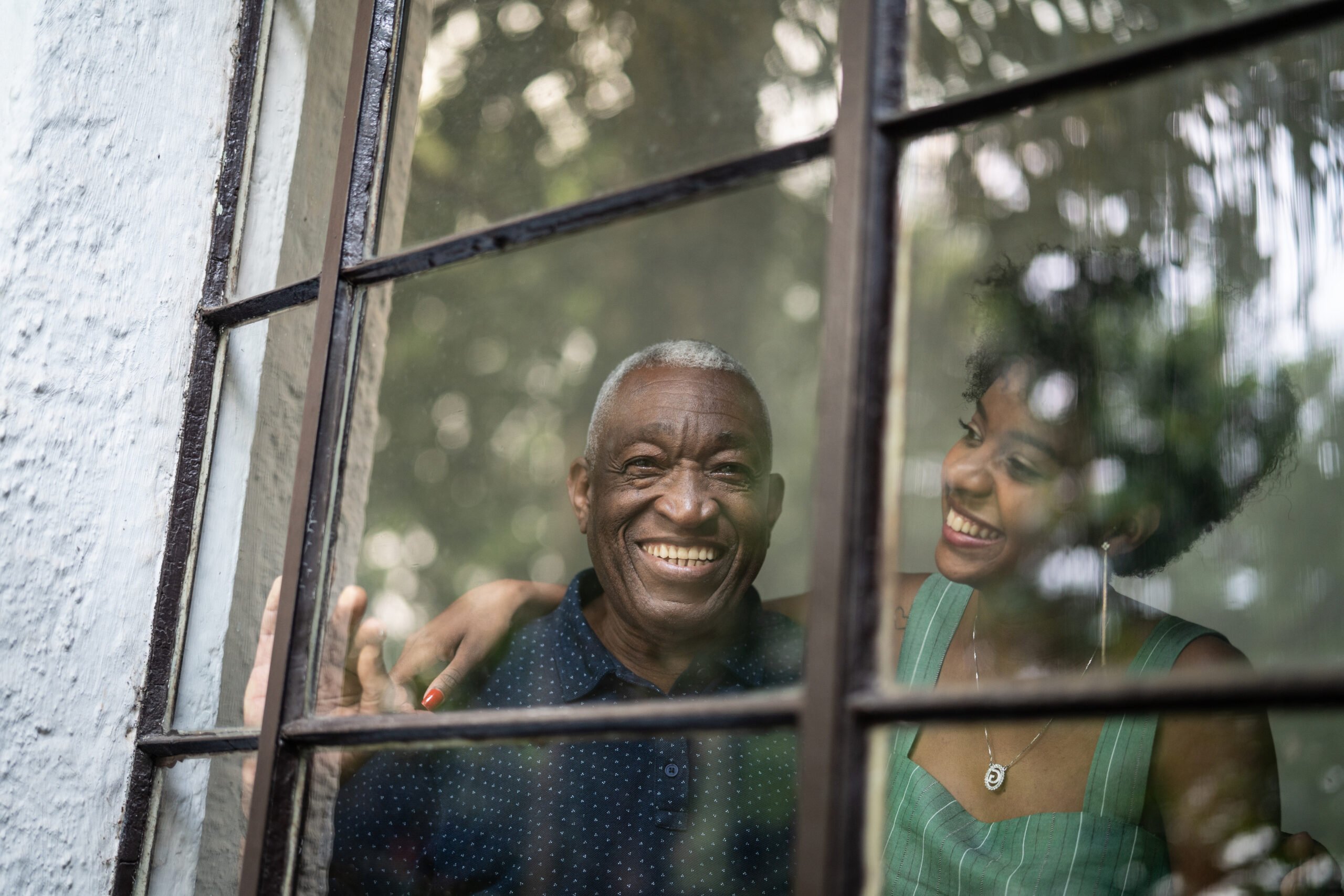 woman and her dad though window