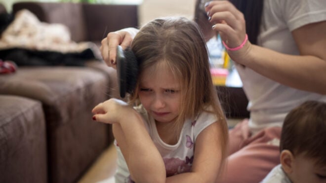 girl crying hair brushing