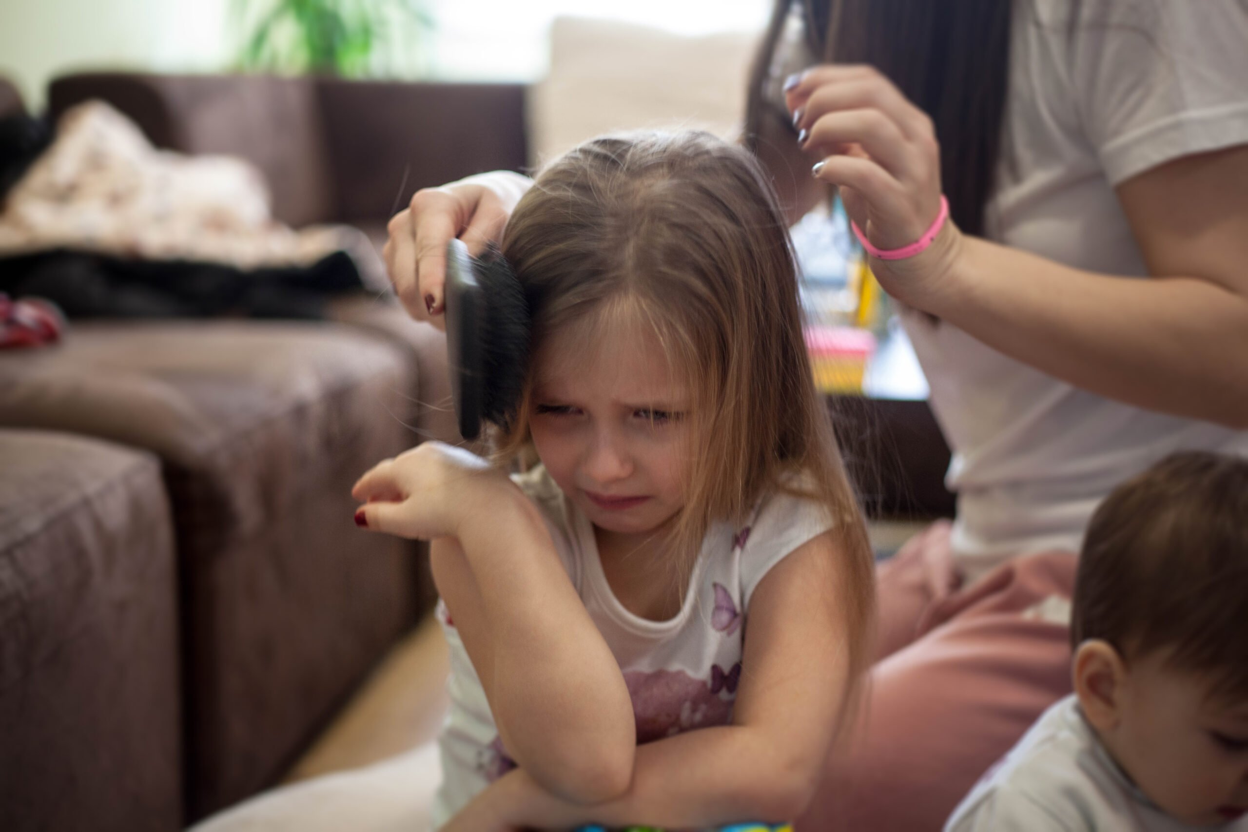 girl crying hair brushing