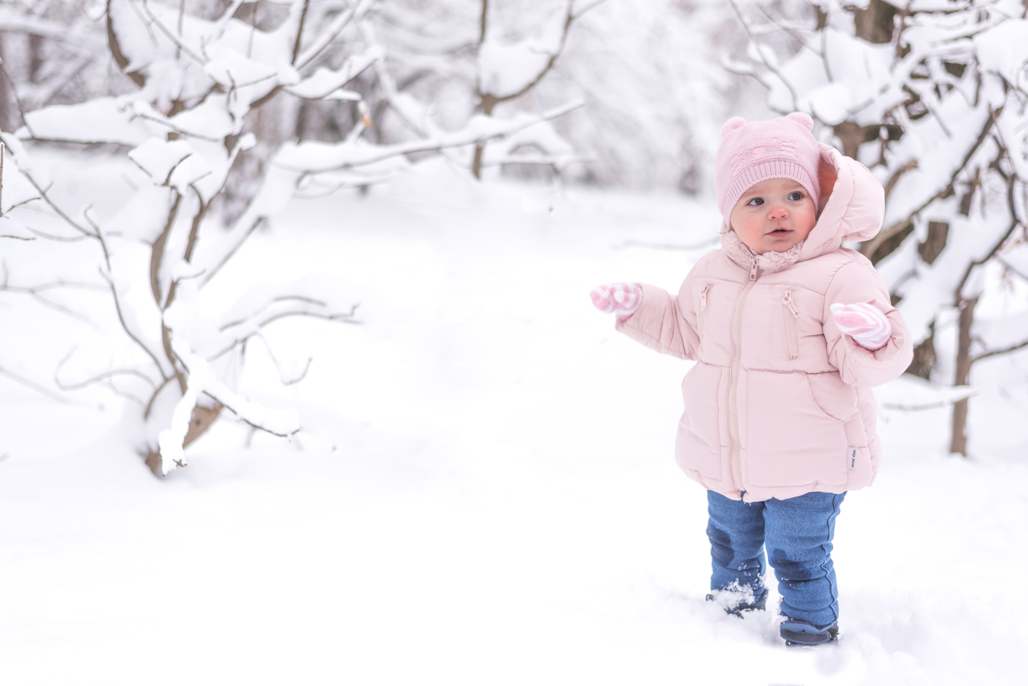 Baby is having fun playing in snow during wintertime