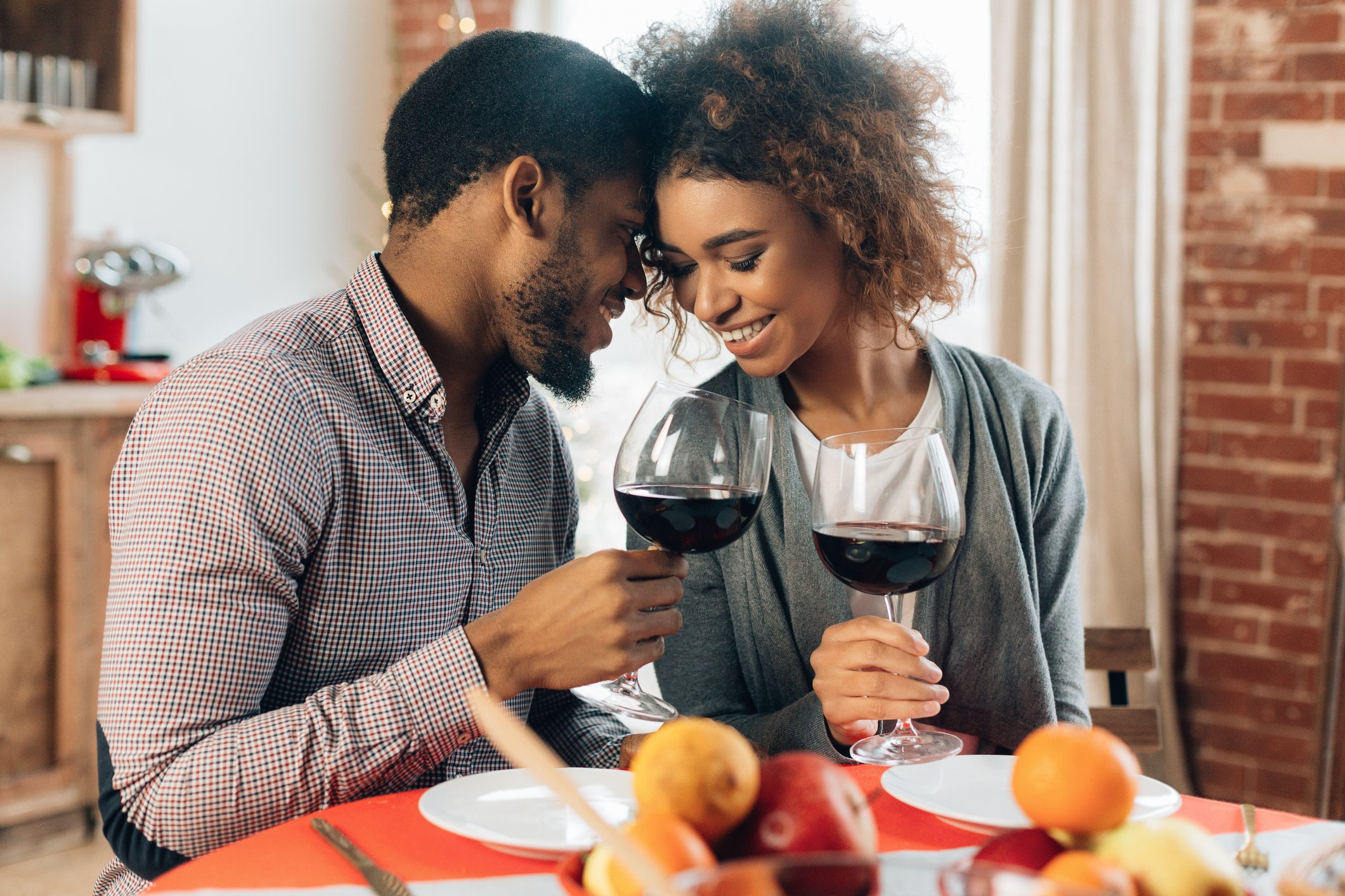 African-american couple enjoying romantic dinner at home