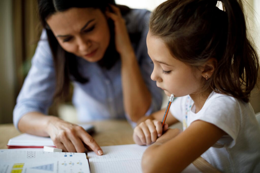 mom helping daughter with homework