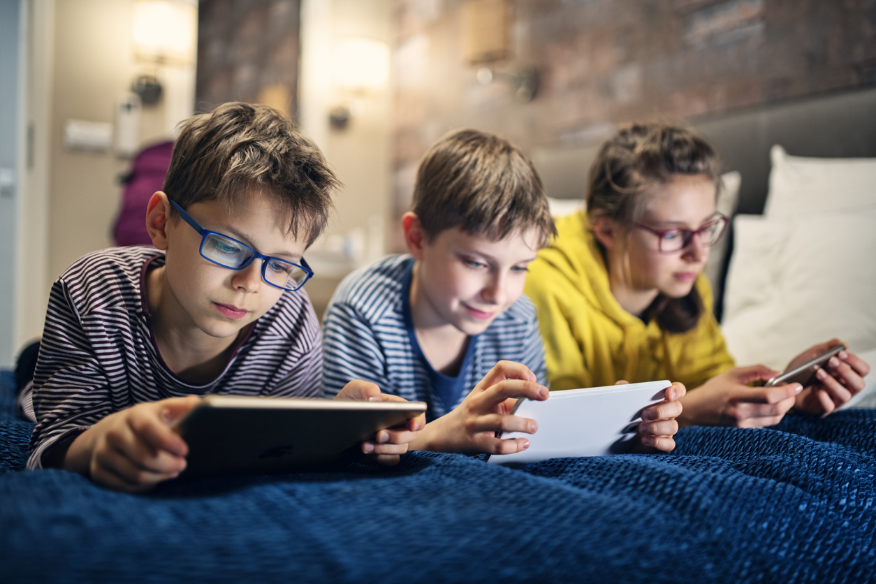 Kids playing with modern mobile devices