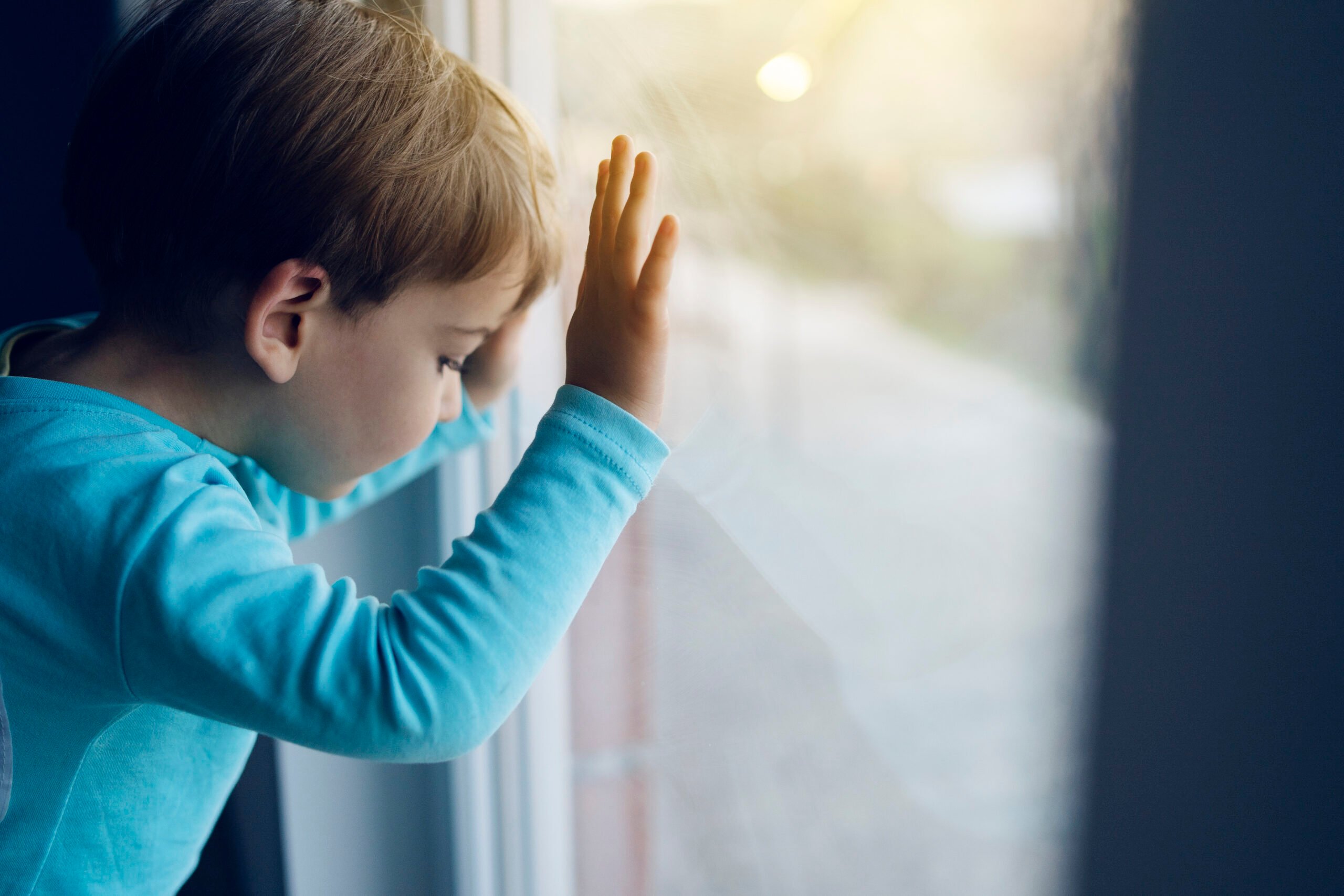 boy looking out window