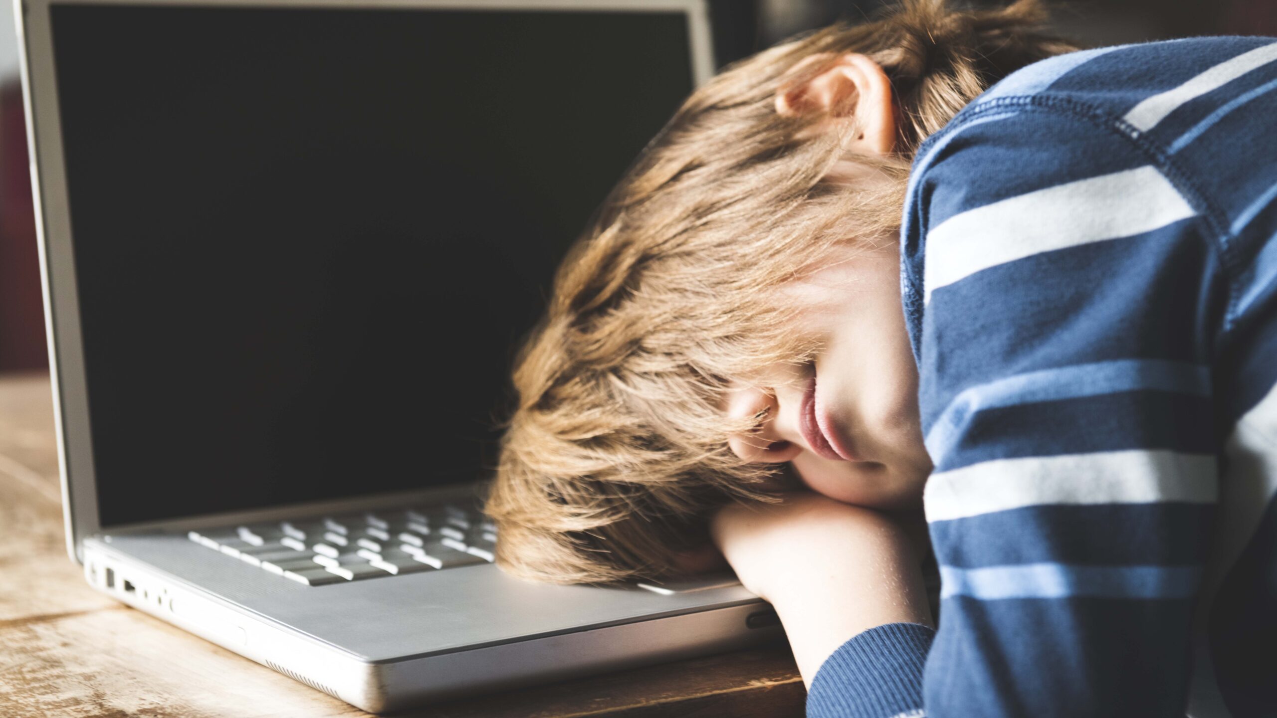 Frustrated boy at laptop — learning delay
