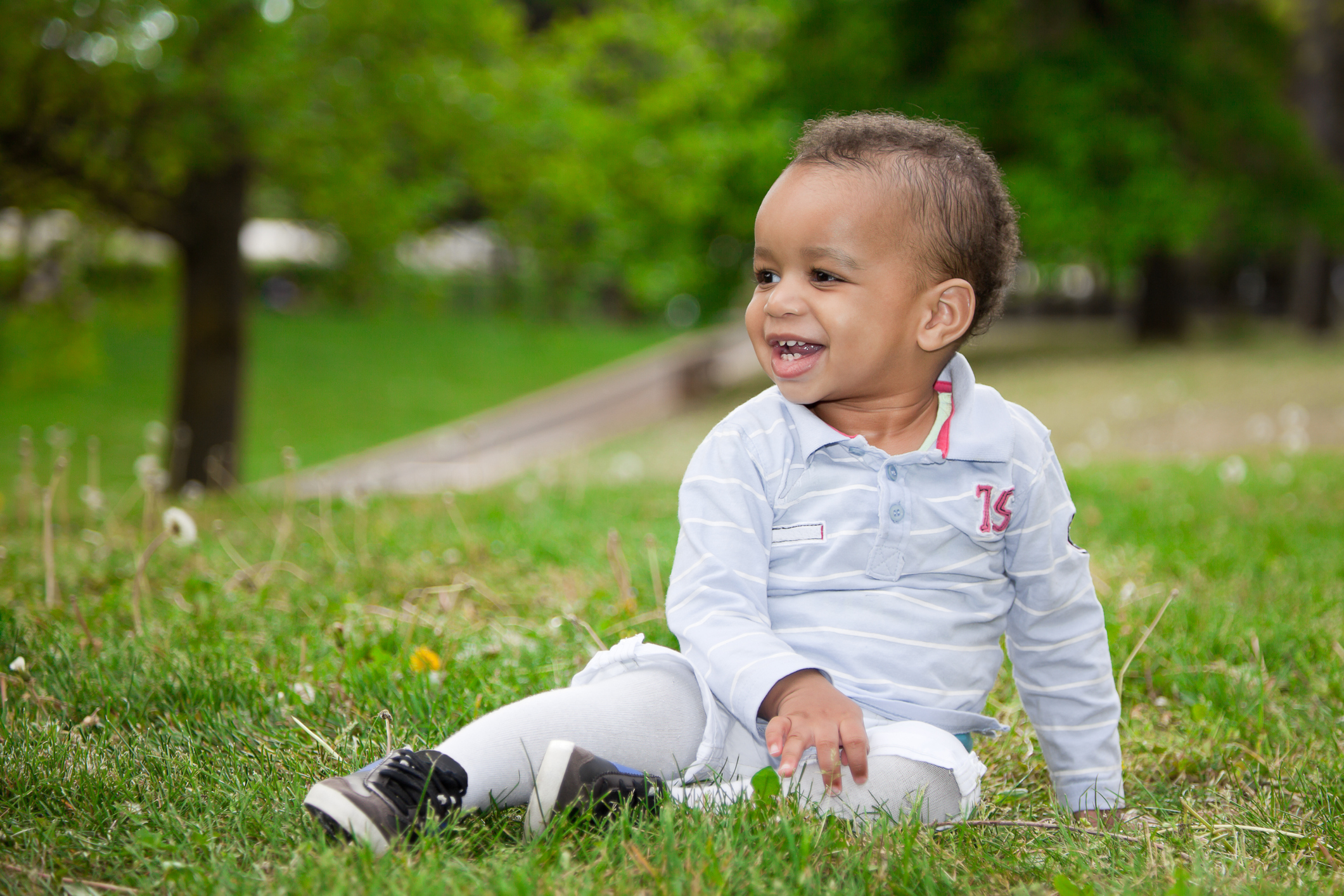 Portrait of a black baby boy playing in the park