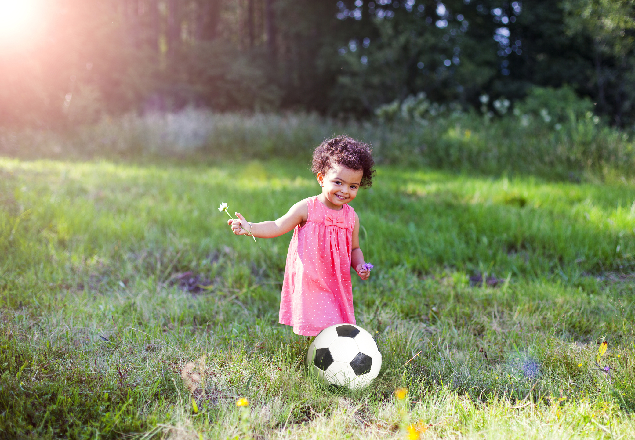 Toddler and the soccer ball outside