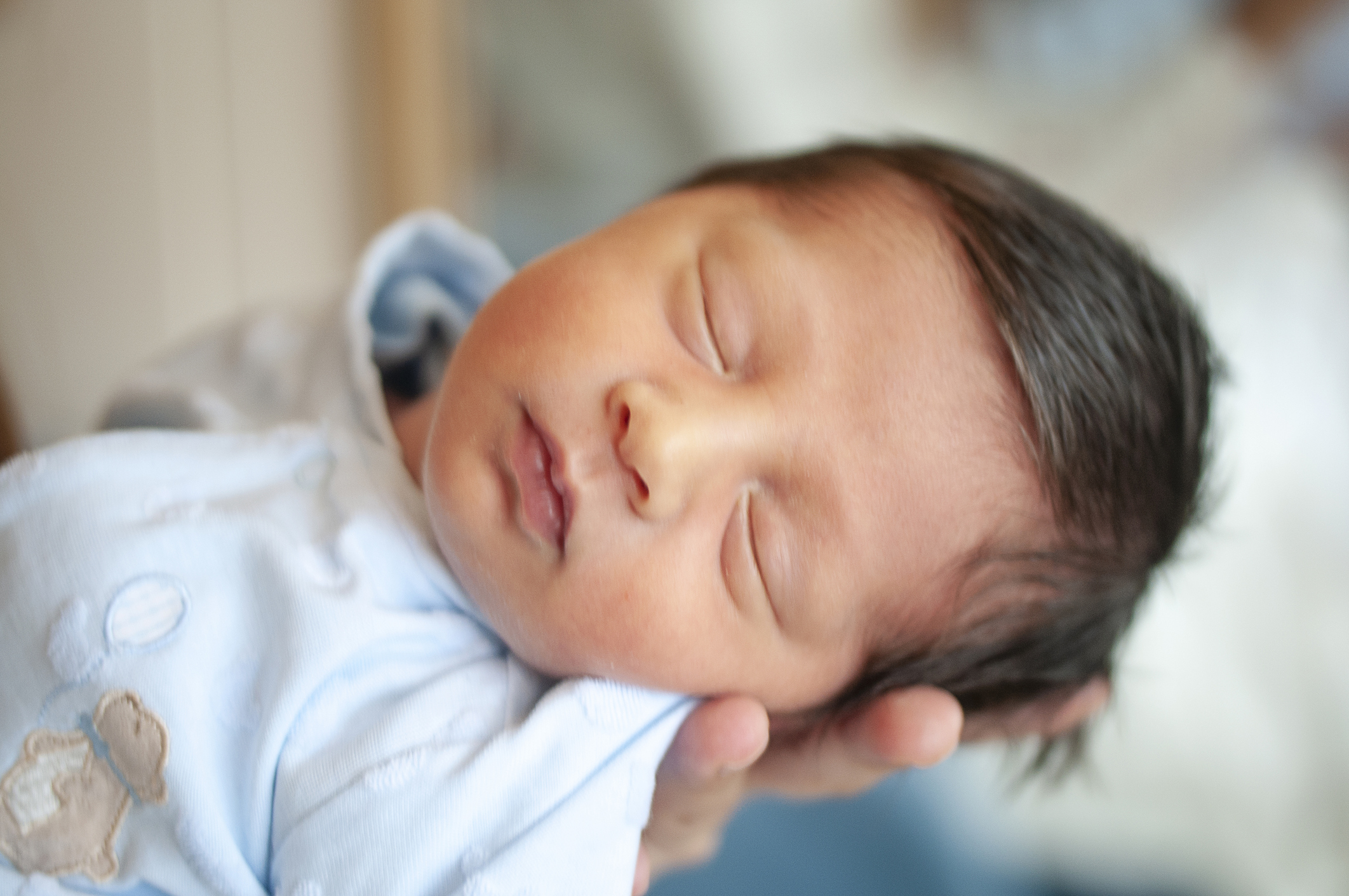 Mother holding her newborn baby boy