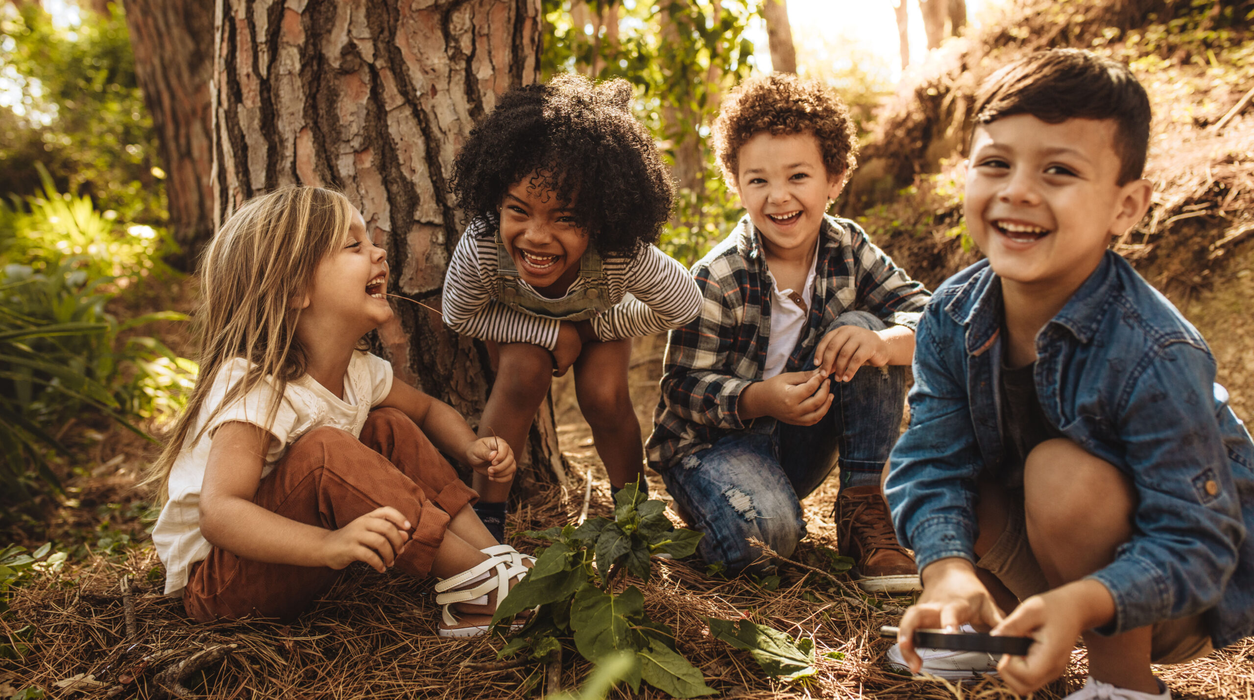Group of cute kids playing in forest