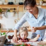 A mother helping her daughter in the kitchen