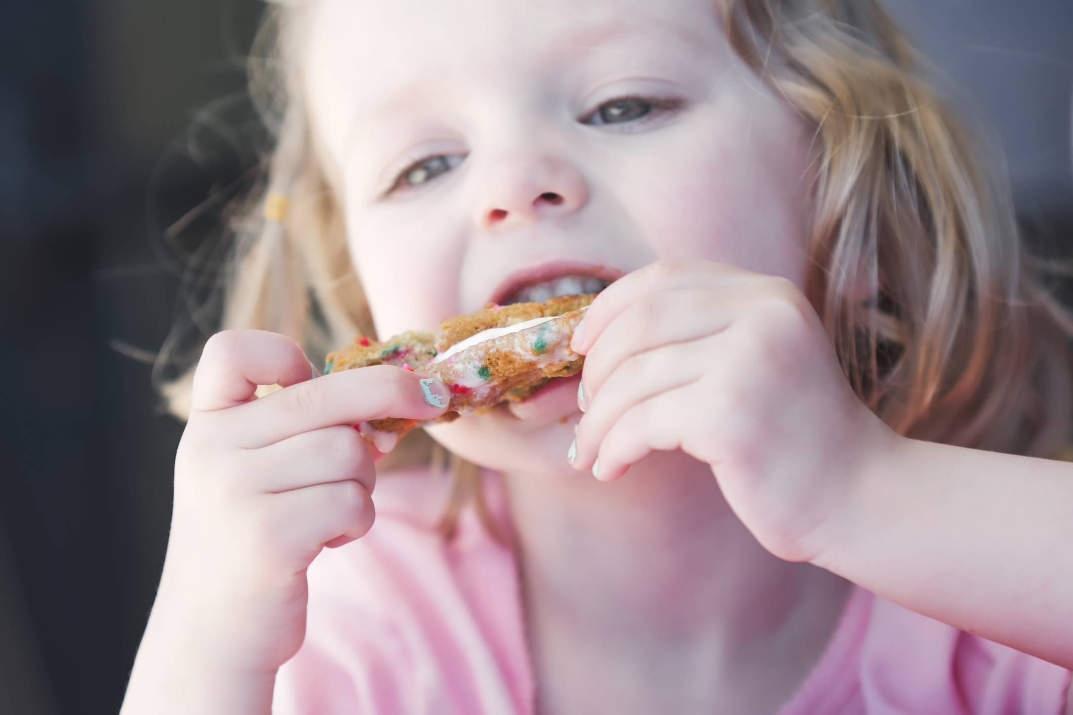 Young girl eating ice cream sandwich