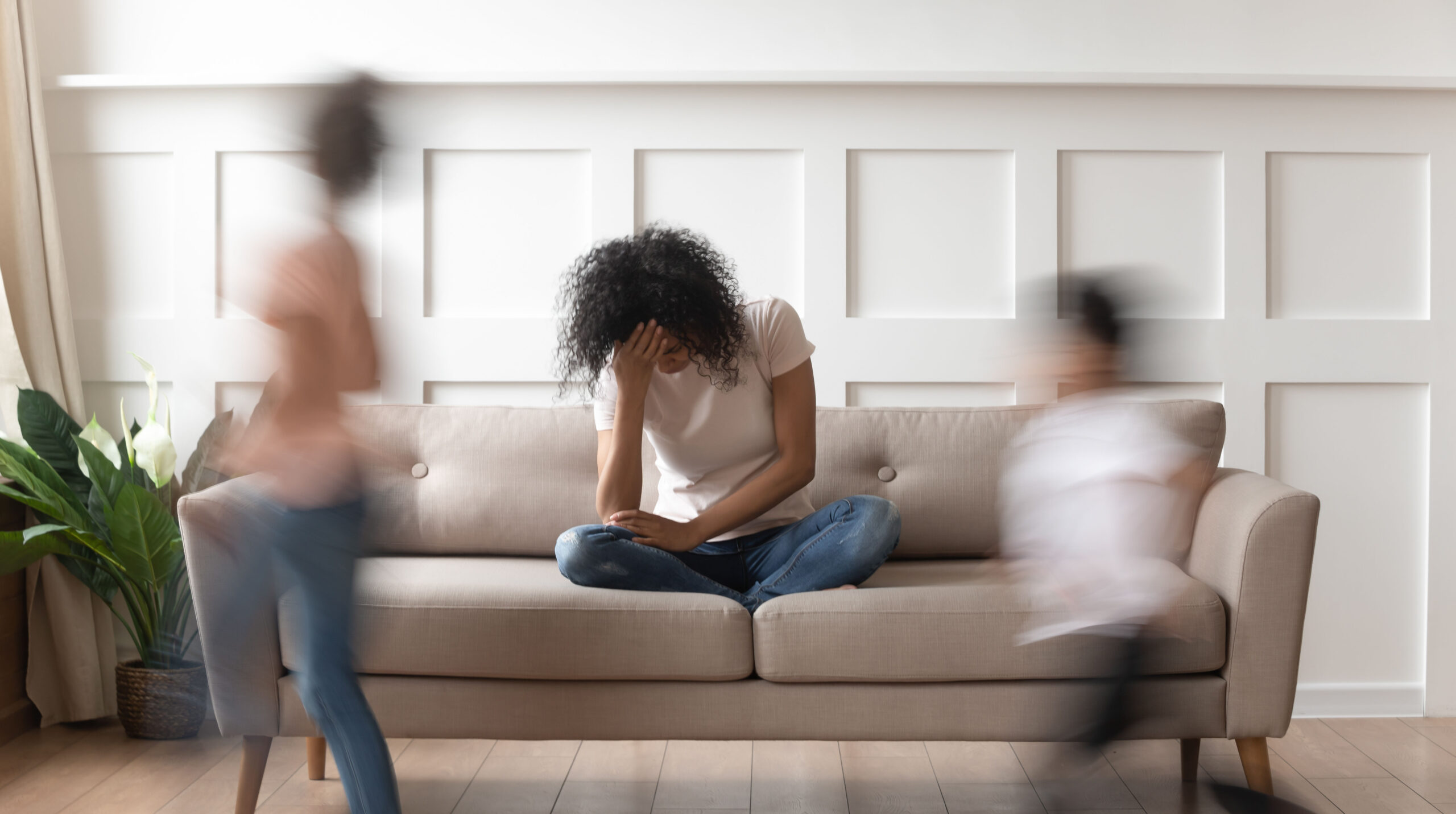Frustrated stressed african mom feel tired annoyed about noisy kids