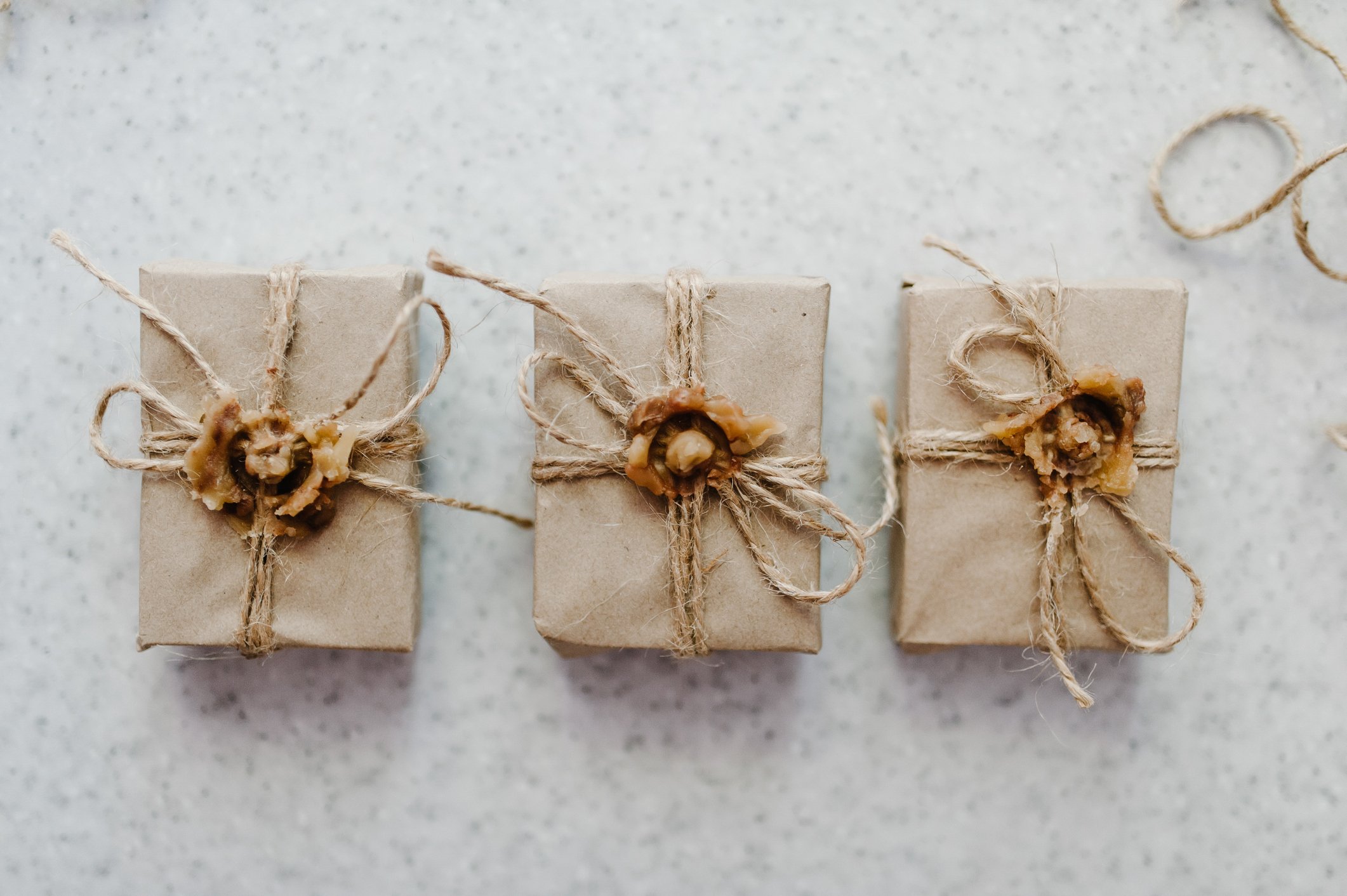 Vintage gift, present boxes with bow on the wooden background pastel. Flat lay. Close up shot a small handmade gift. Gift wrapping.