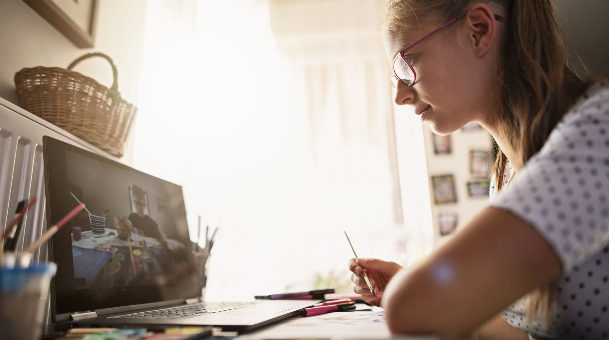 Teenage girl learning painting from YouTube