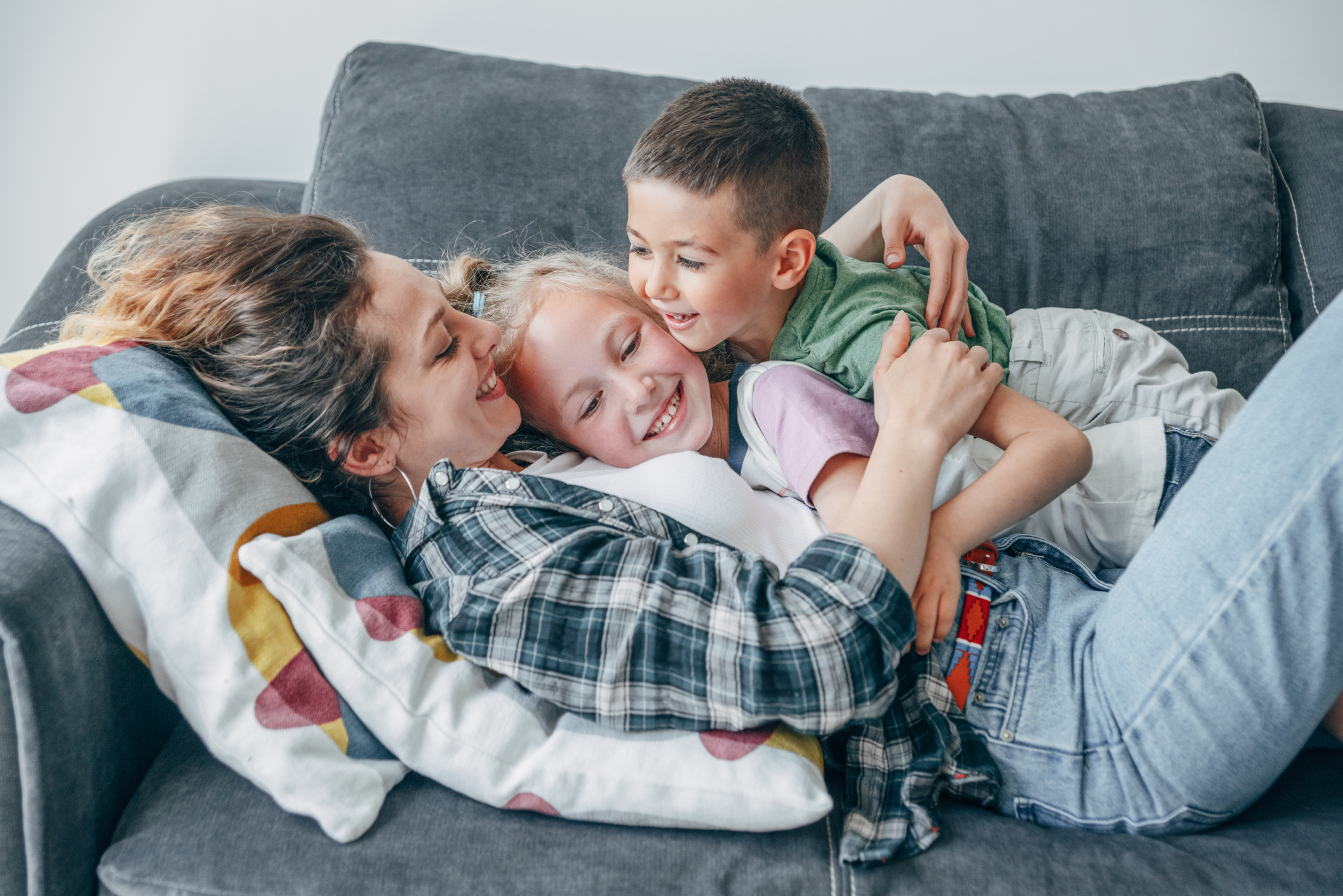 mom hugging two kids