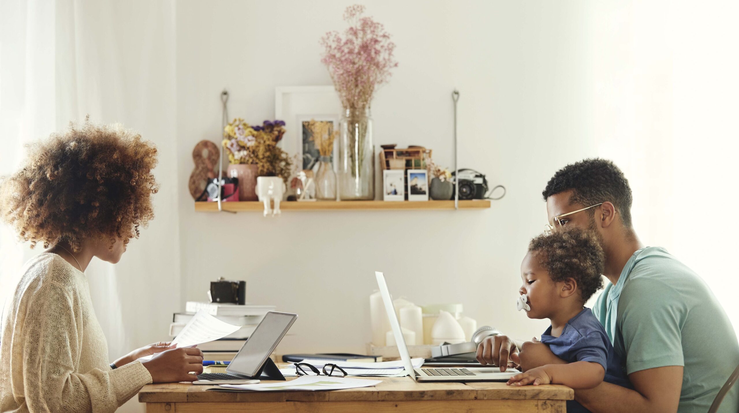 Parents using computer while sitting with boy