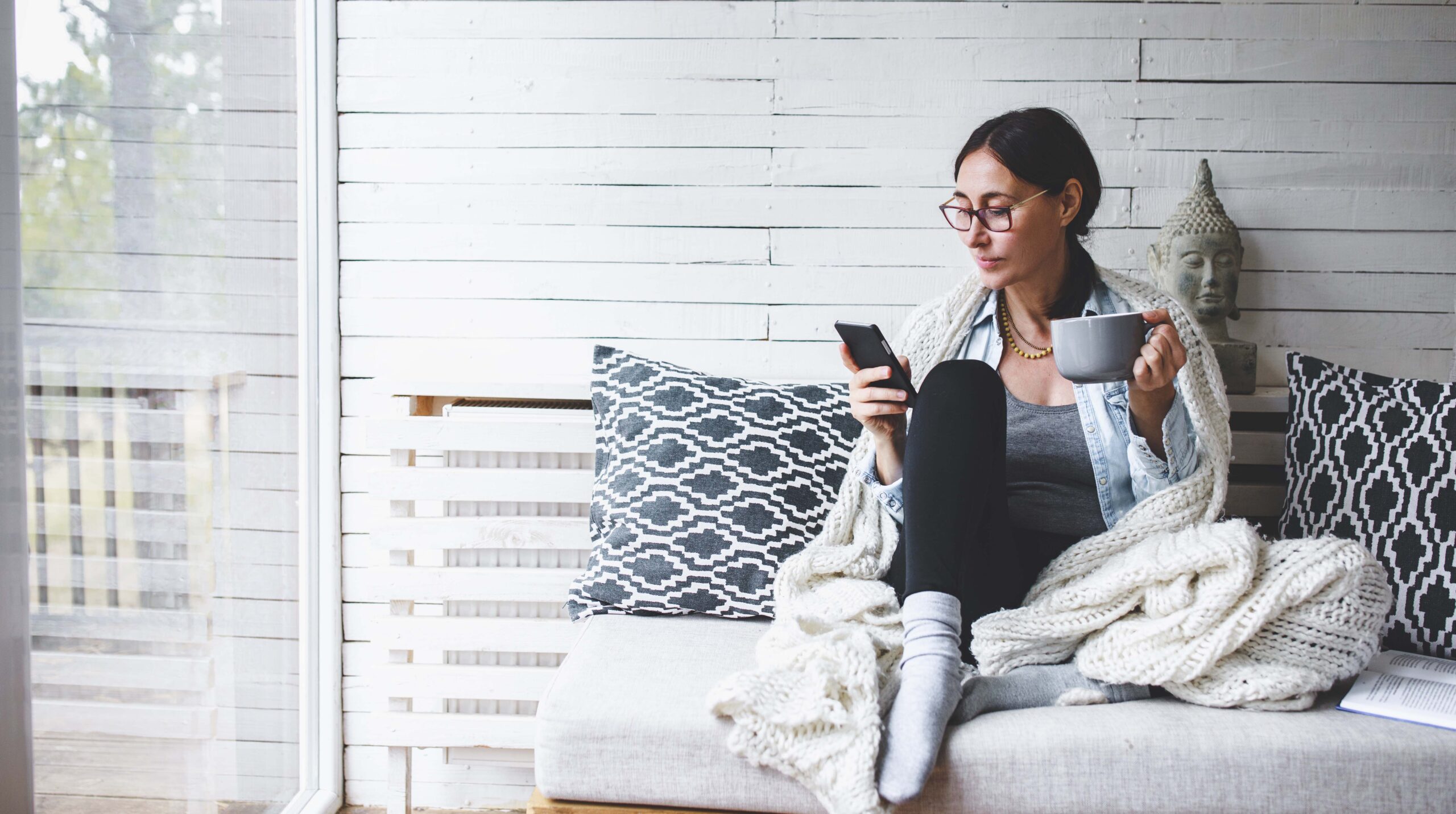Middle-aged woman siting comfortable and enjoys tea